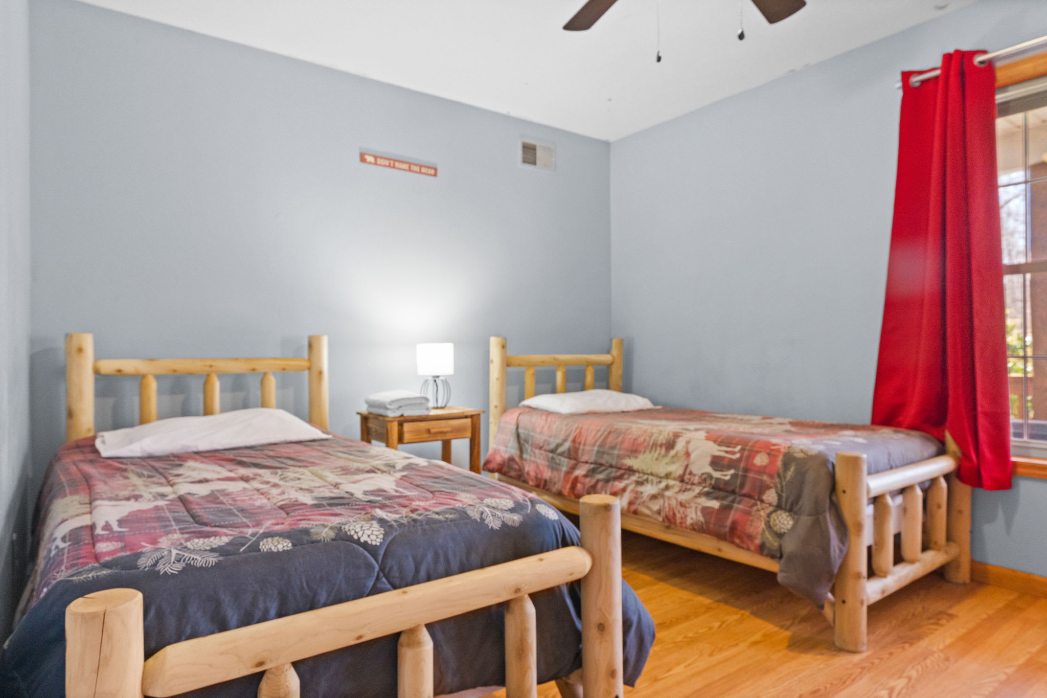 The bedroom opens to treetop views with a ceiling fan for comfort