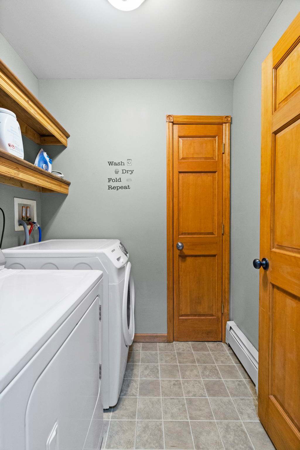 Laundry essentials with a cheerful reminder to wash, dry, fold, and repeat