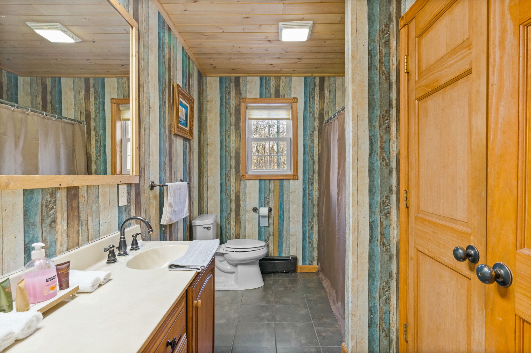 Fresh towels and toiletries ready for you in the wood-accented bathroom