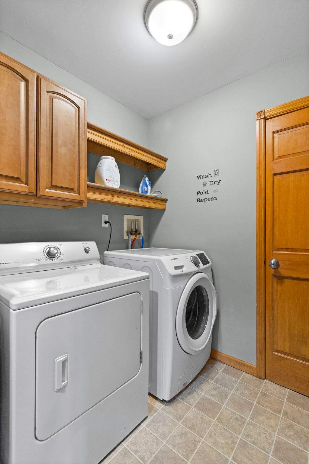 Full-size washer and dryer tucked away for easy access