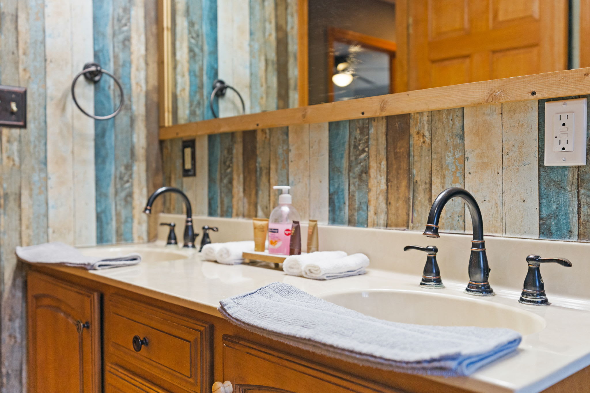 Vanity close-up with bronze fixtures, folded towels, and thoughtful touches