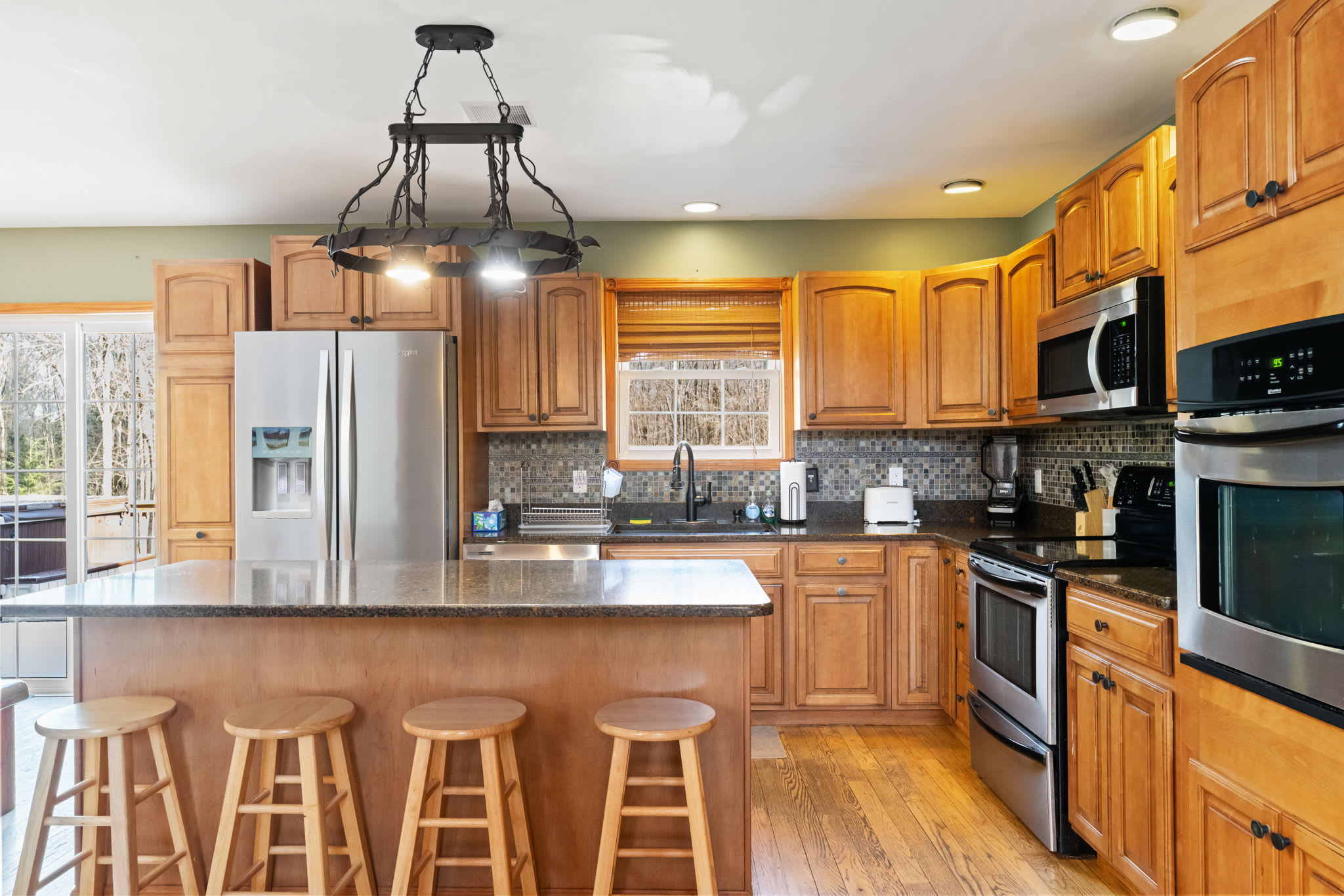 Gather around the granite island in the fully equipped kitchen