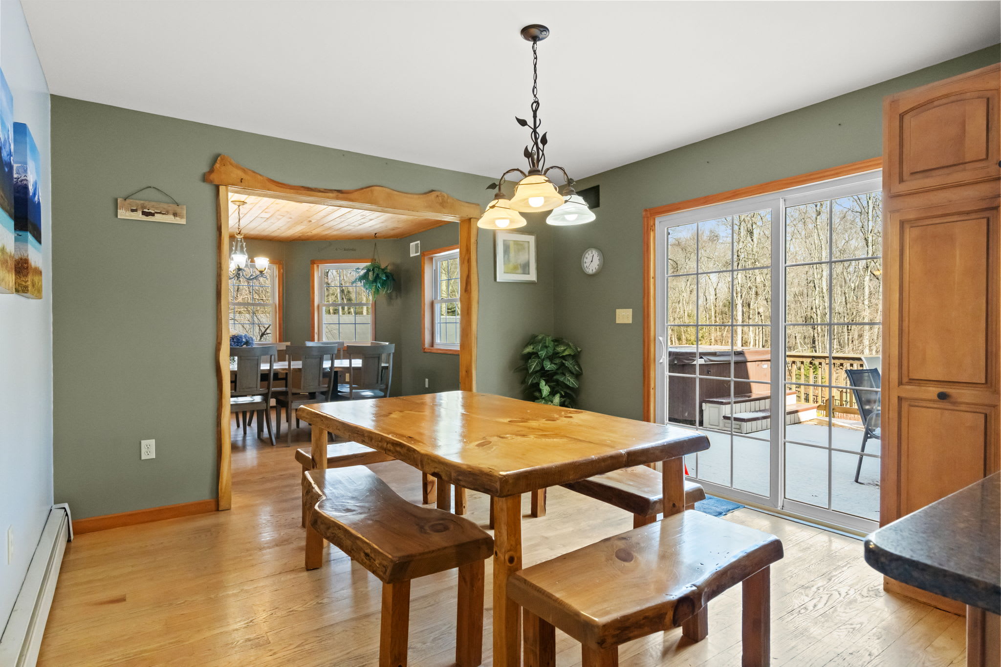 Rustic dining table with bench seating and sliding doors to the deck