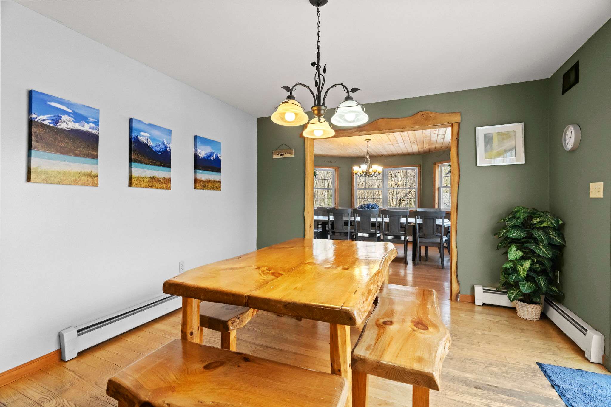 Sunny dining area with a wooden table and chandelier for memorable meals together