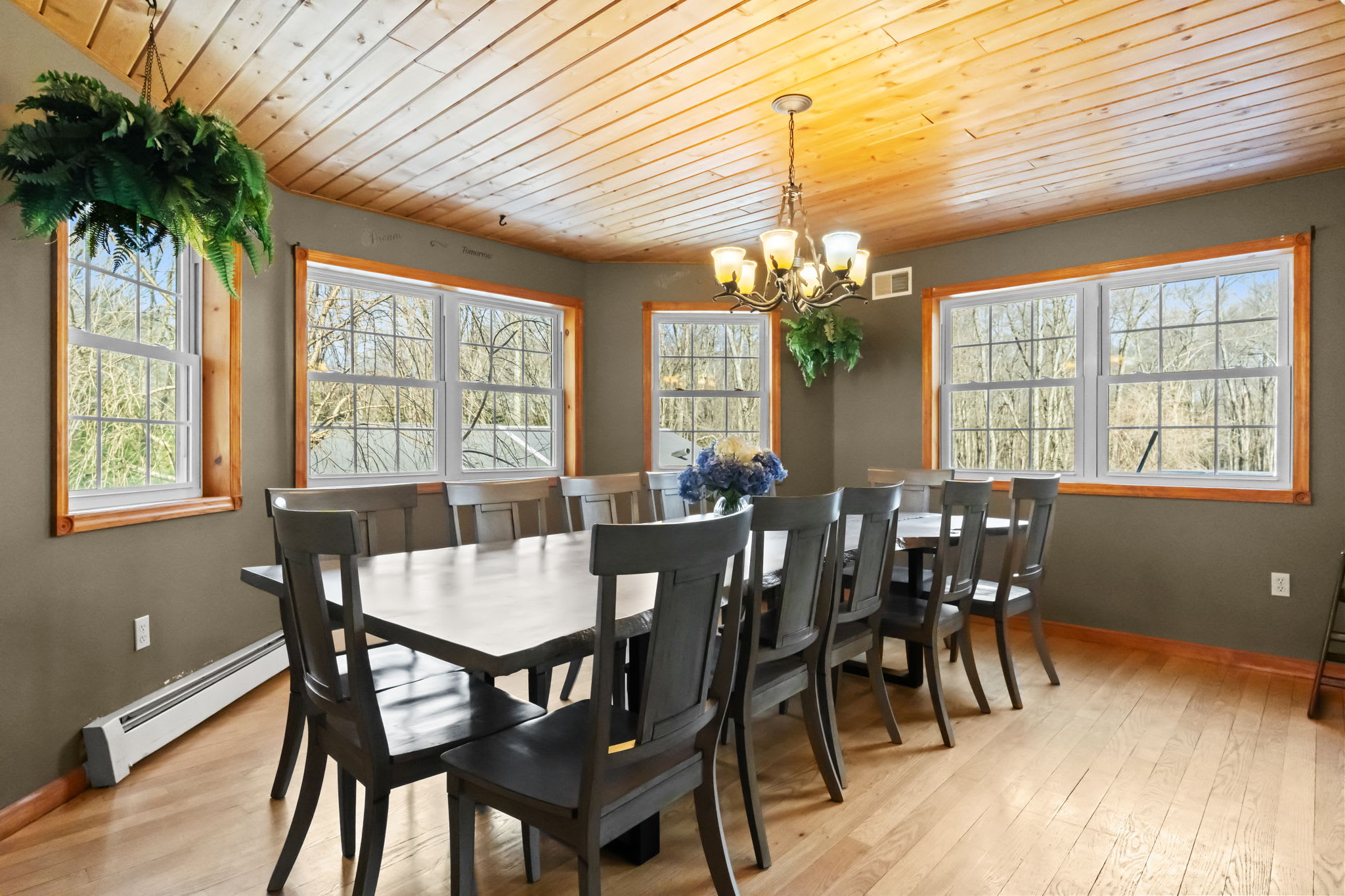 Gather around the formal dining table with hardwood floors and natural light