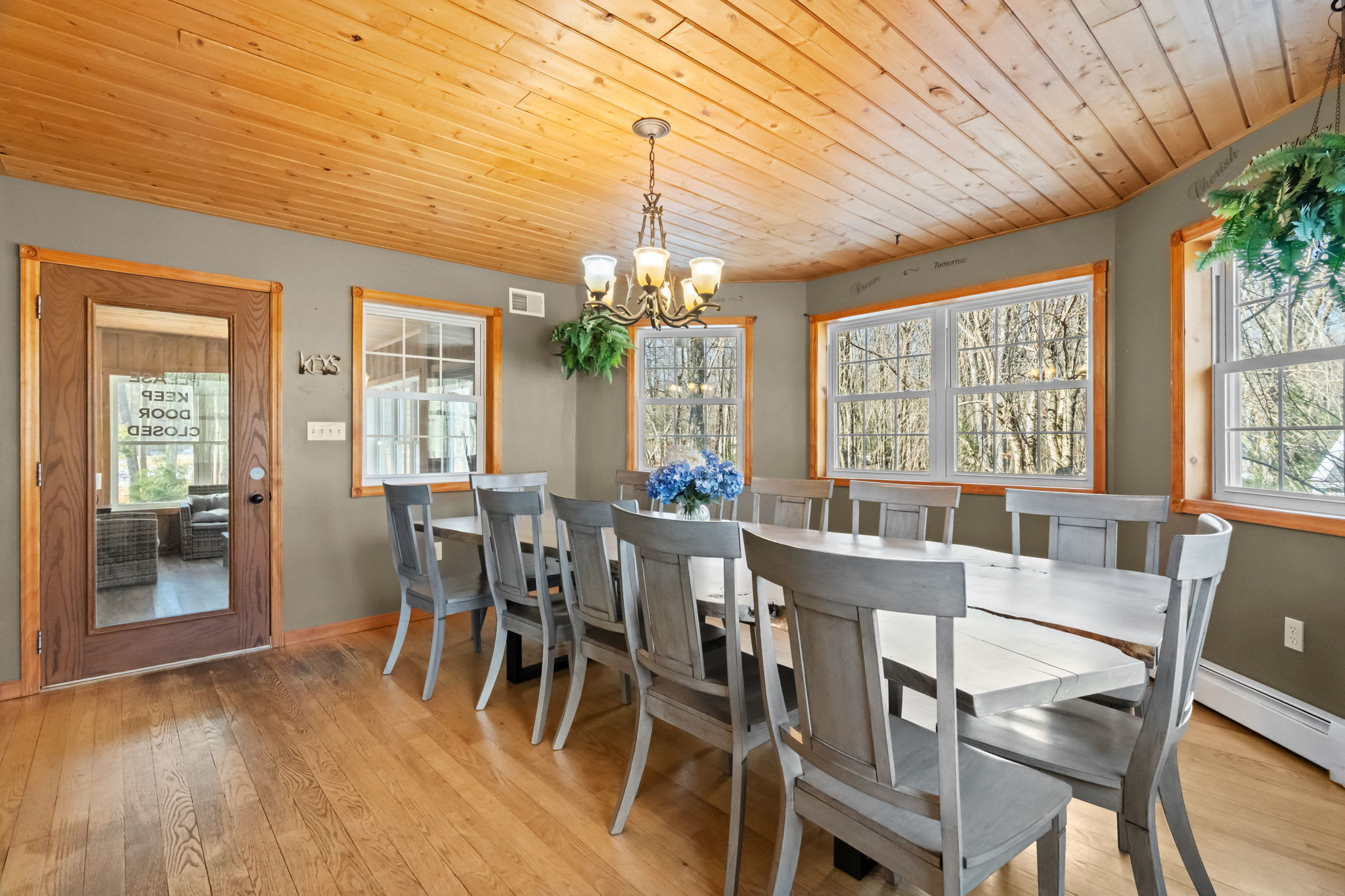 The second dining area seats the whole group under a wood-paneled ceiling