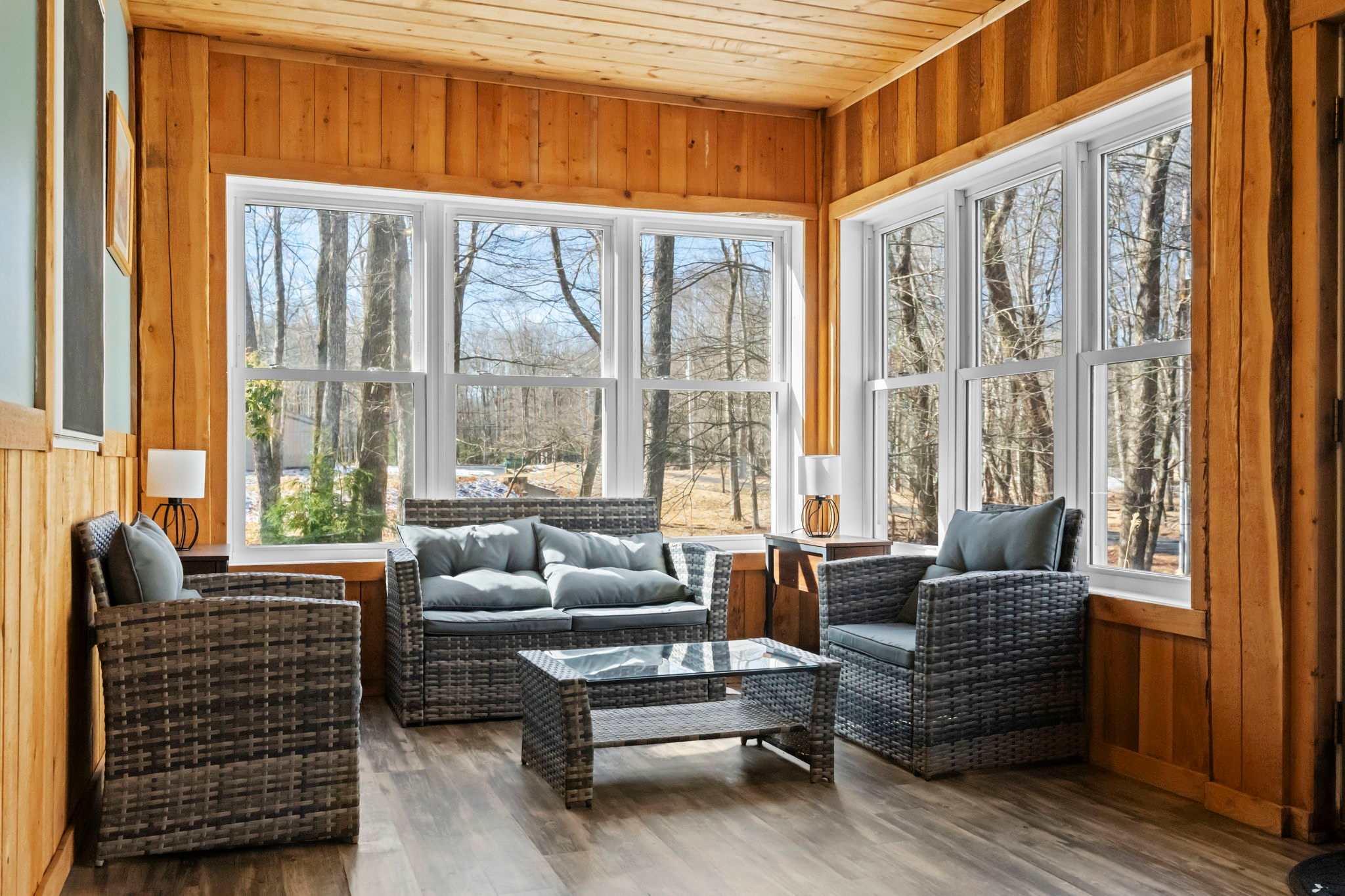Sink into cozy seating in the wood-paneled living area with plenty of natural light