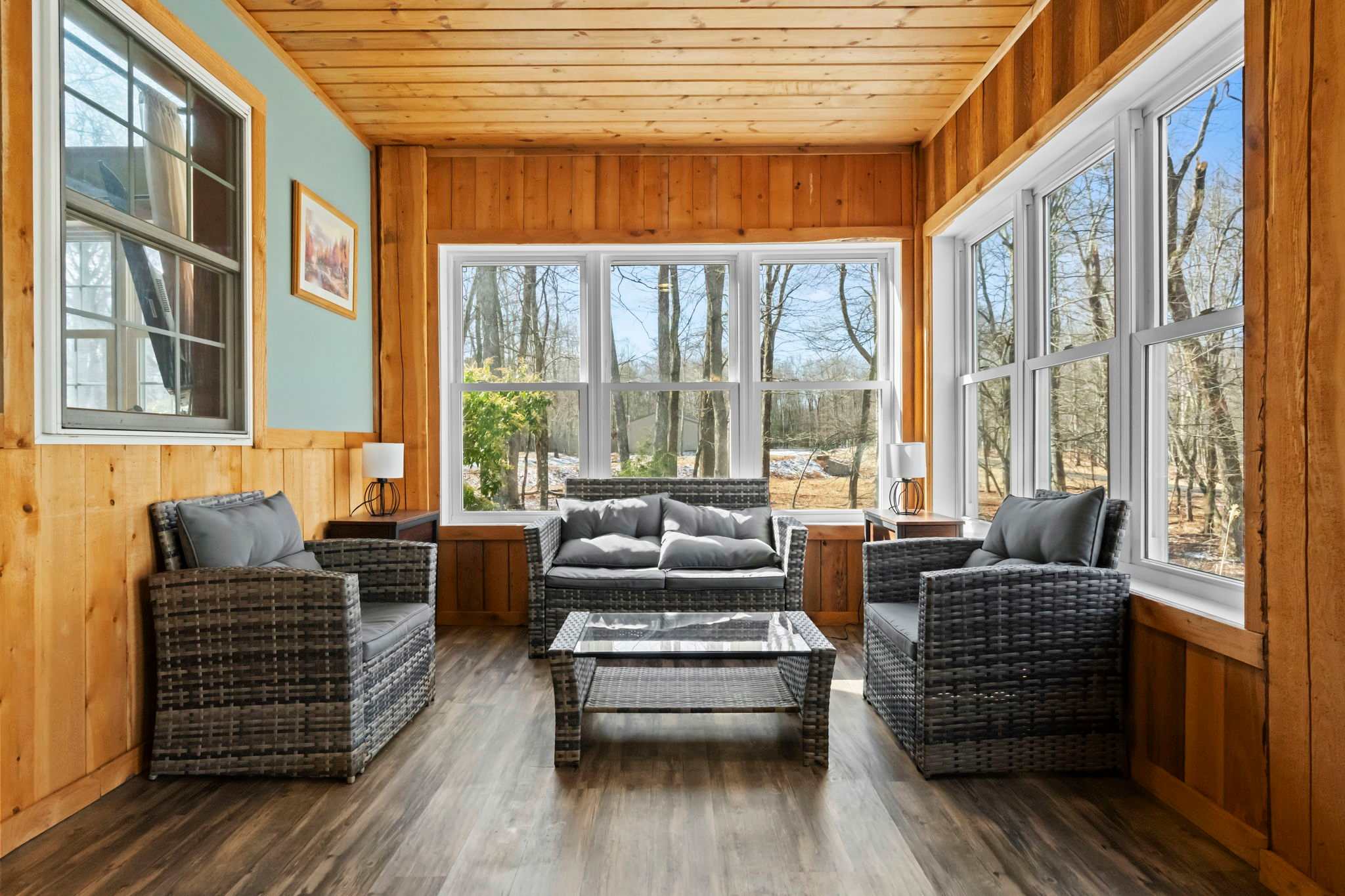 Unwind in the sunroom with wicker seating and views of the trees