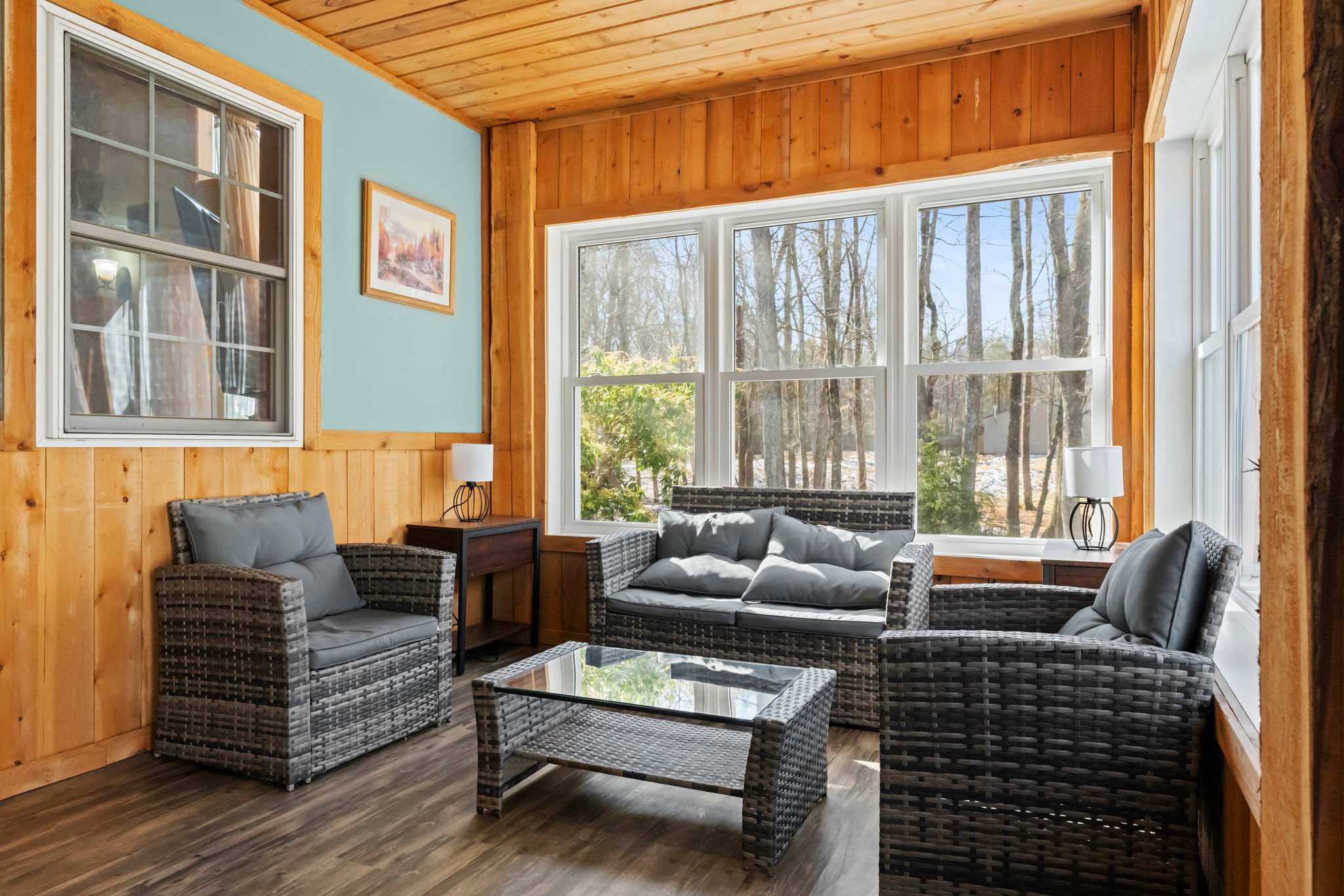 Relax in the sunlit lounge with comfortable seating and teal accents