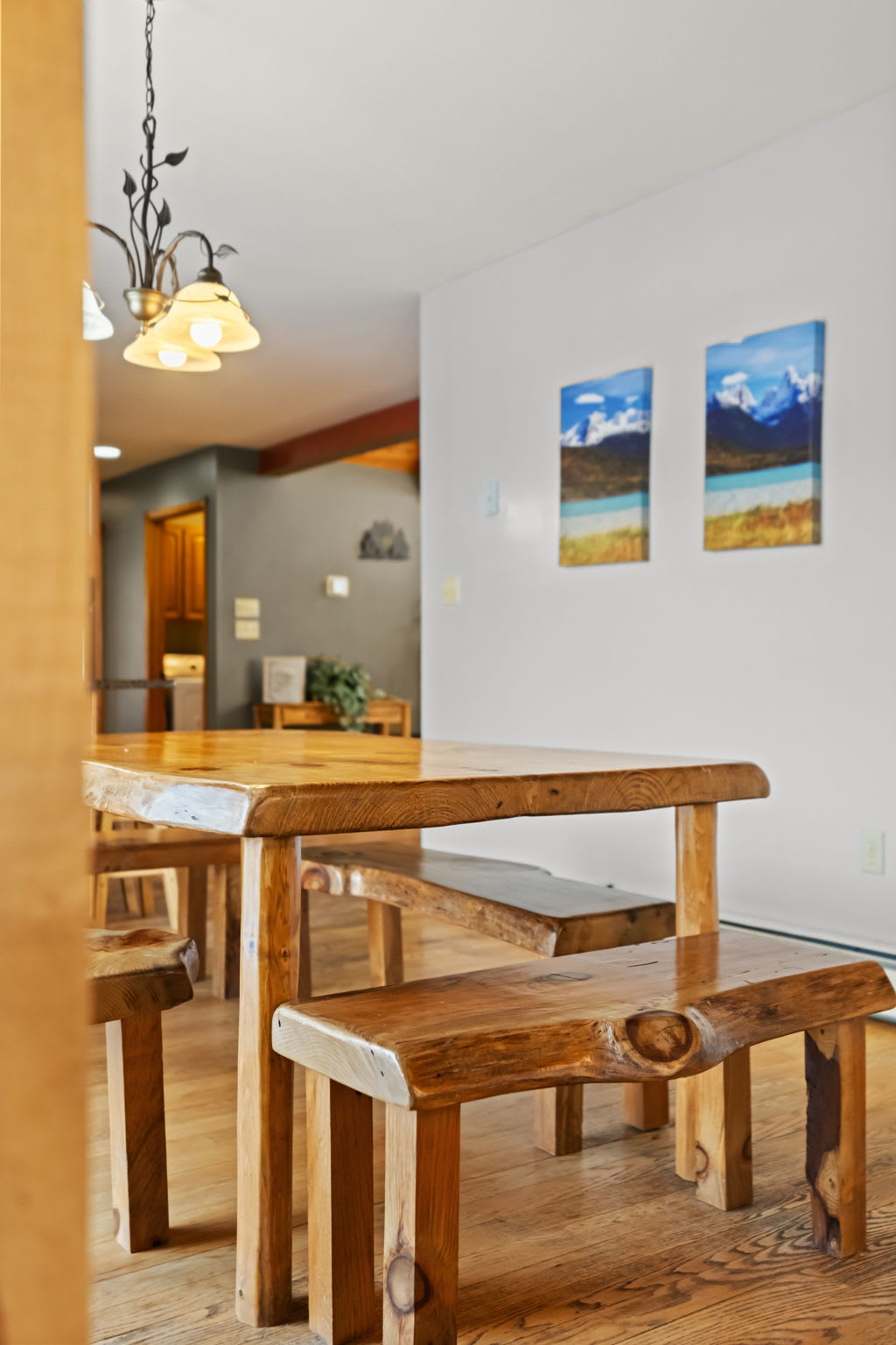 Open kitchen and dining nook bathed in warm light from the chandelier above