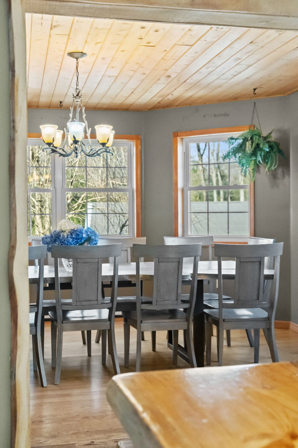 Hardwood floors lead through the open living and dining area filled with sunlight