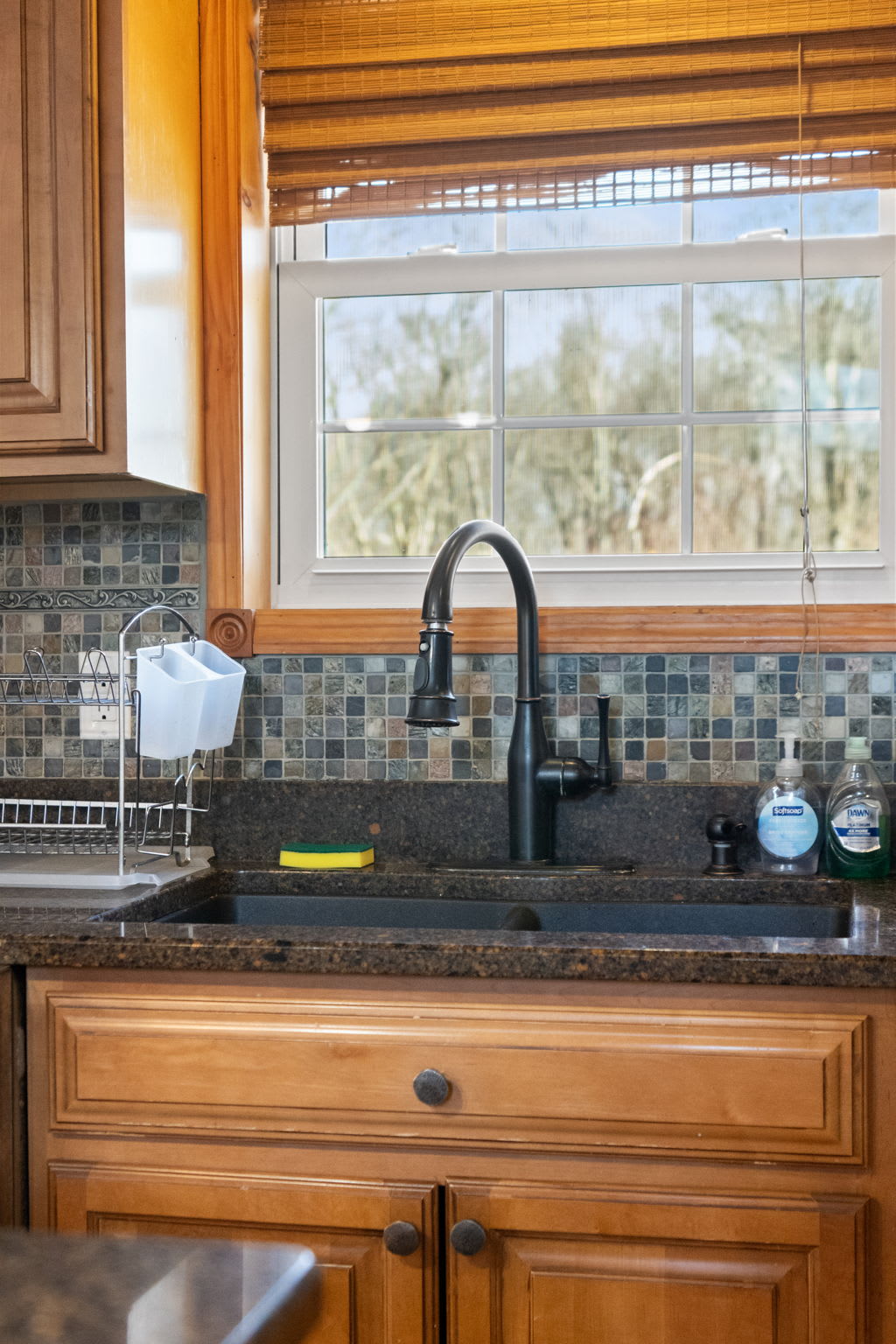 Rustic bathroom vanity with a wooden cabinet and modern dark fixtures