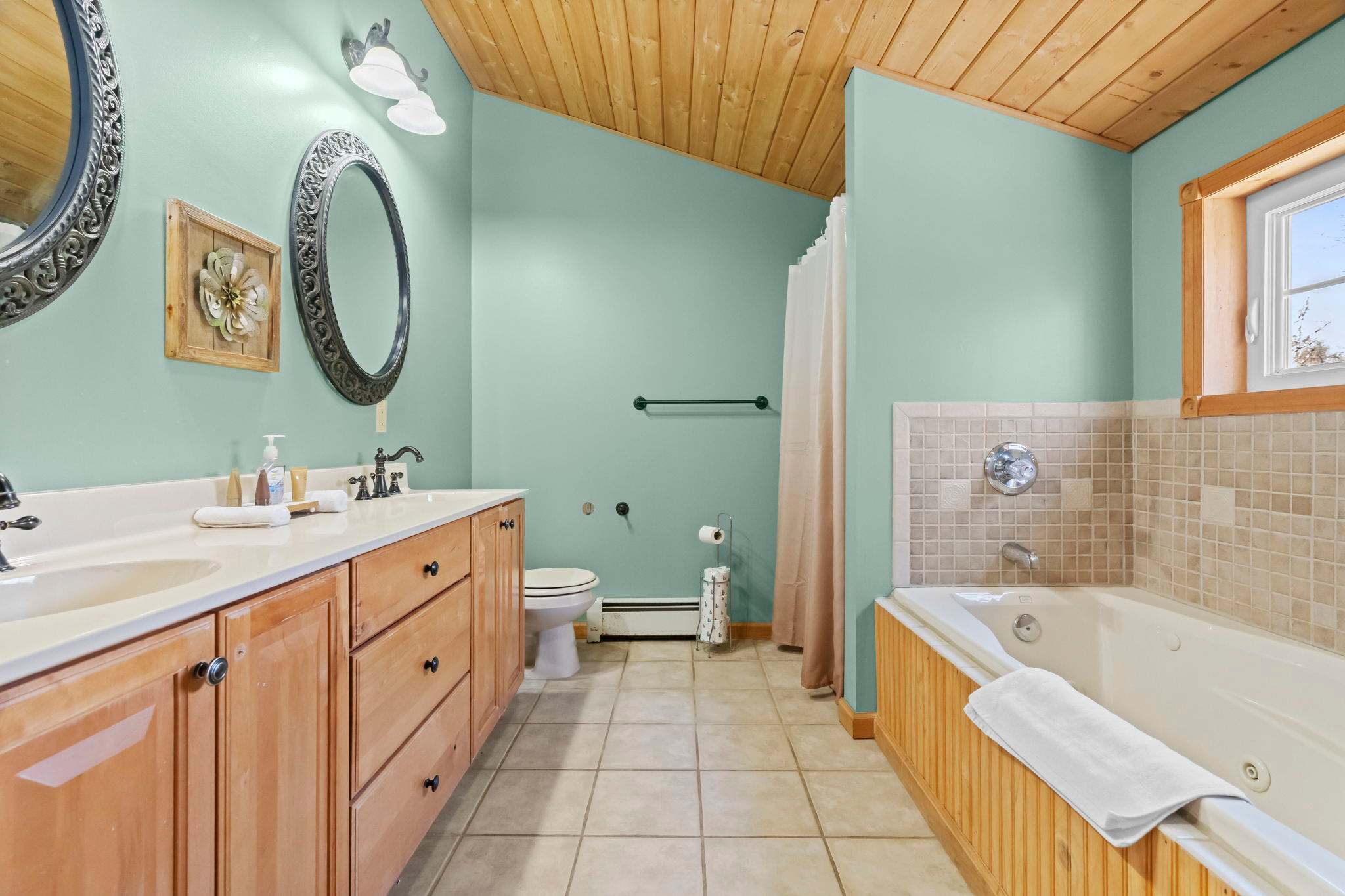 Restful bedroom with wood-paneled walls and an attached bathroom just steps away