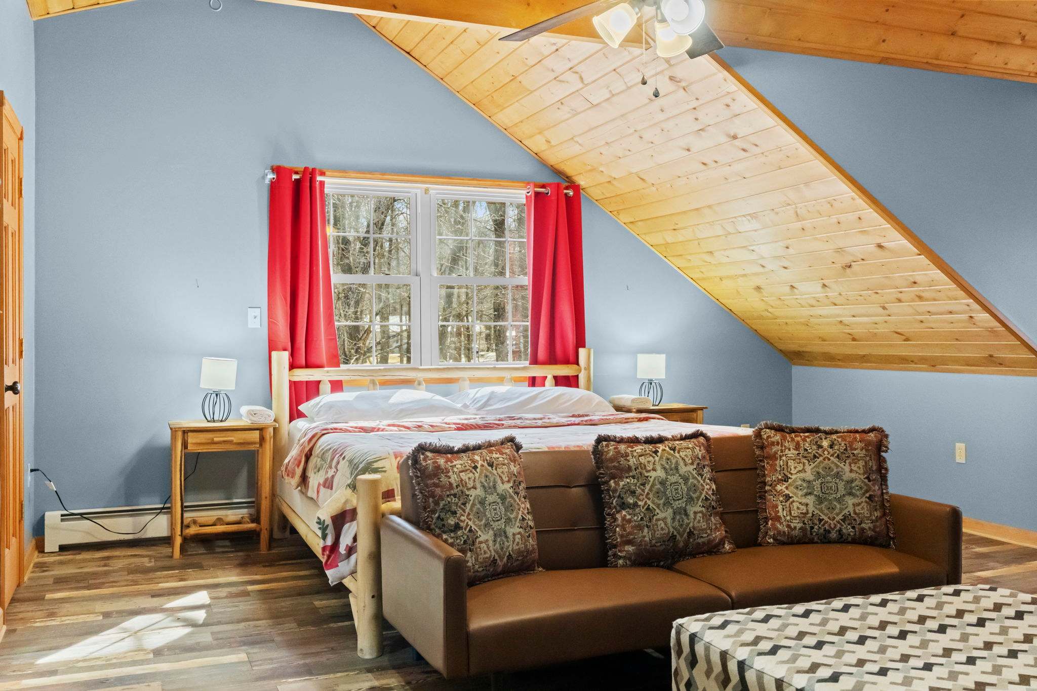 Warm and inviting bedroom with an area rug and exposed wood beam ceiling