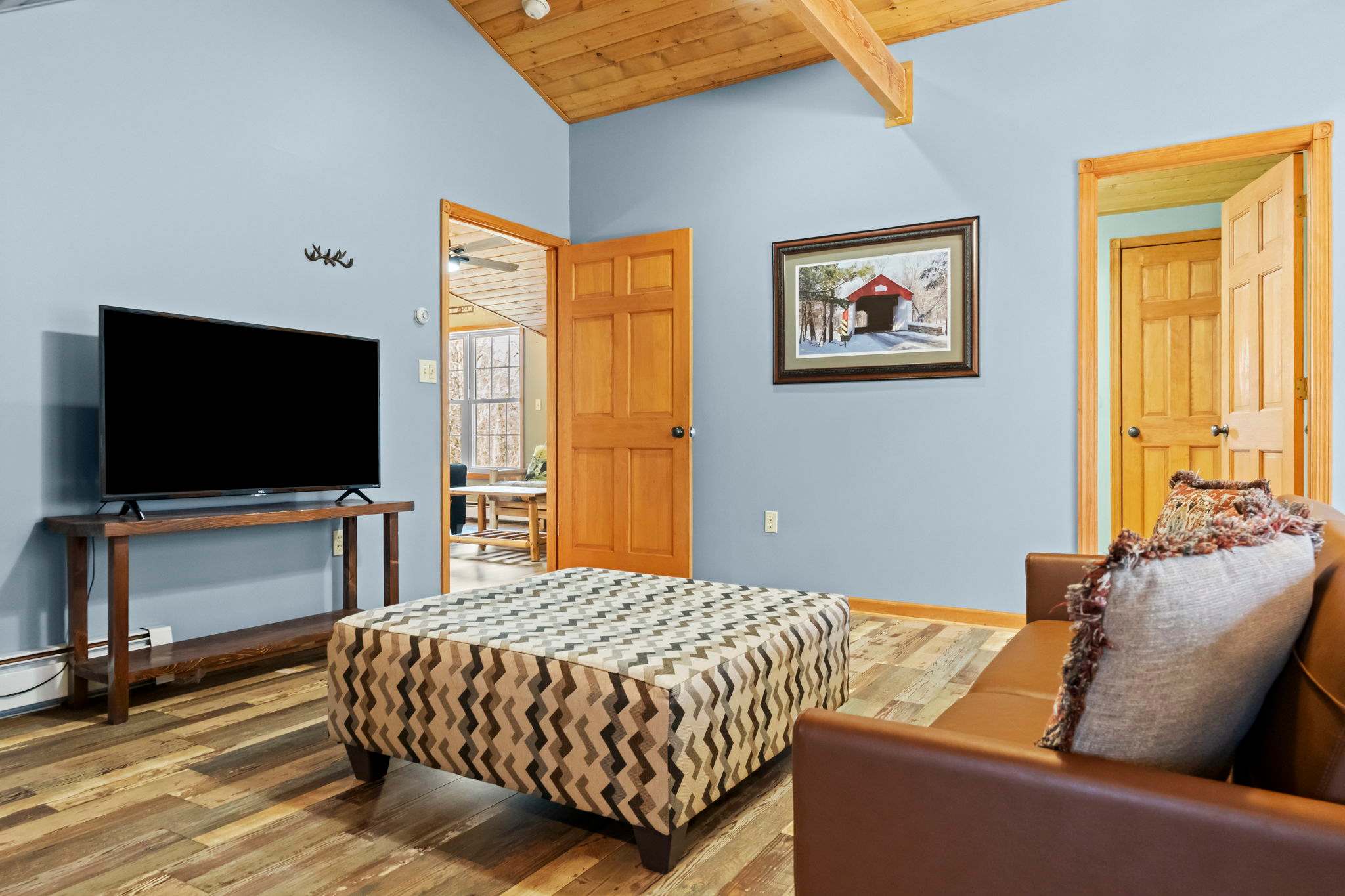 Snug cabin bedroom with a woven bedspread and natural wood throughout