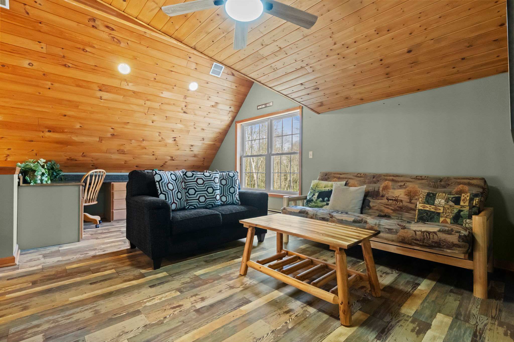 Peek into the cozy loft from above with warm wood beams and soft lighting