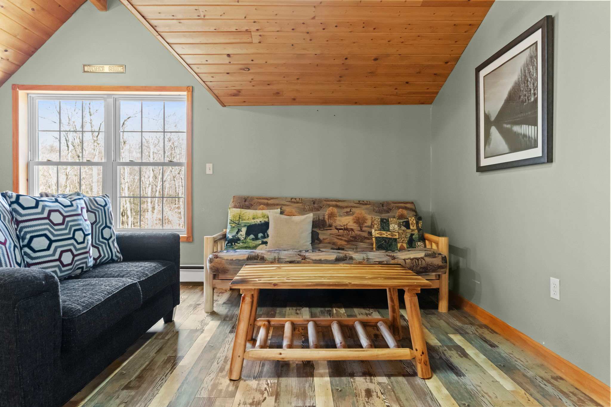 Loft dining nook with a wooden table nestled under the A-frame ceiling