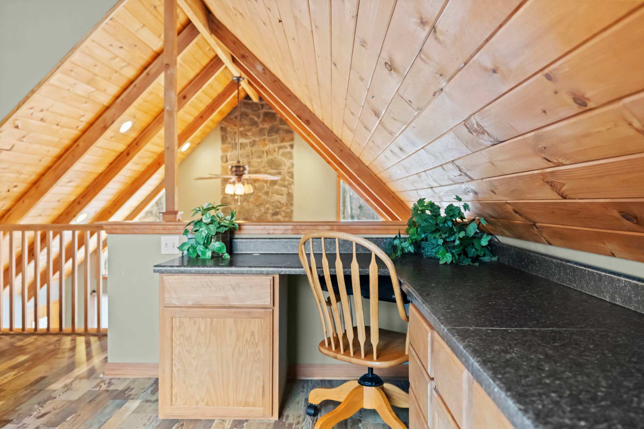 Wooden staircase winds through the cabin with views of the living area below