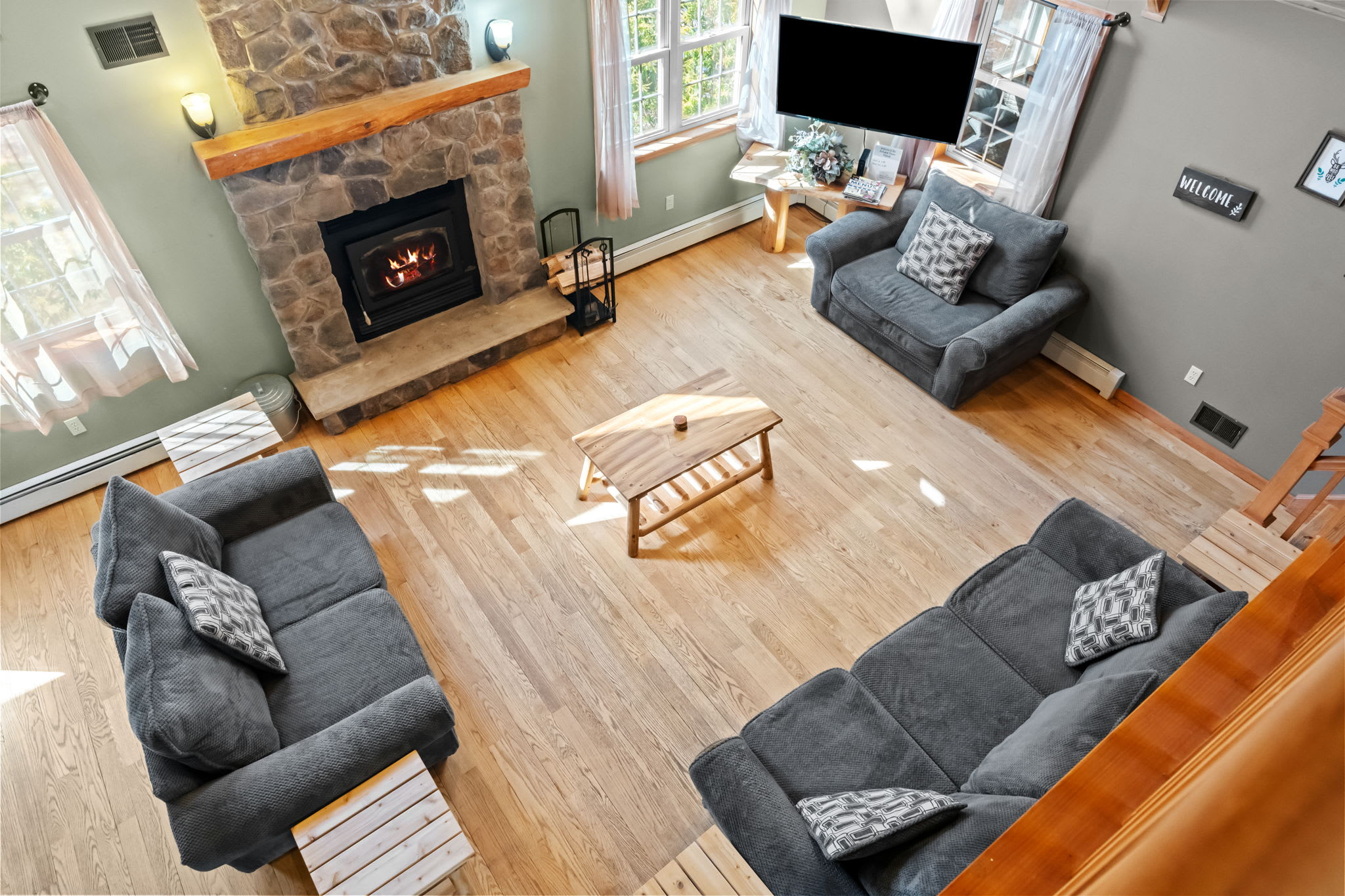 Dramatic vaulted A-frame living room seen from the upper loft level
