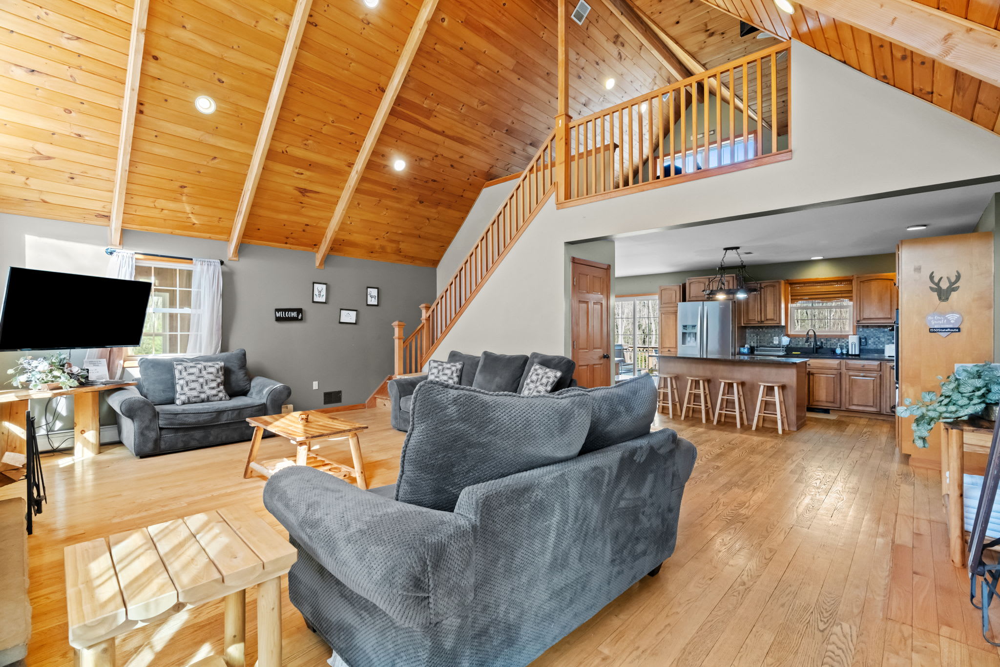 Step inside to vaulted wood ceilings, a stone fireplace, and cozy seating for everyone