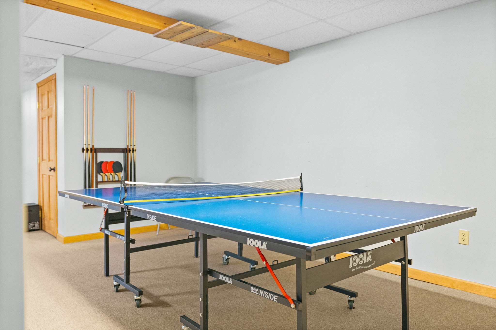 Serve up some fun on the JOOLA ping pong table in the game room