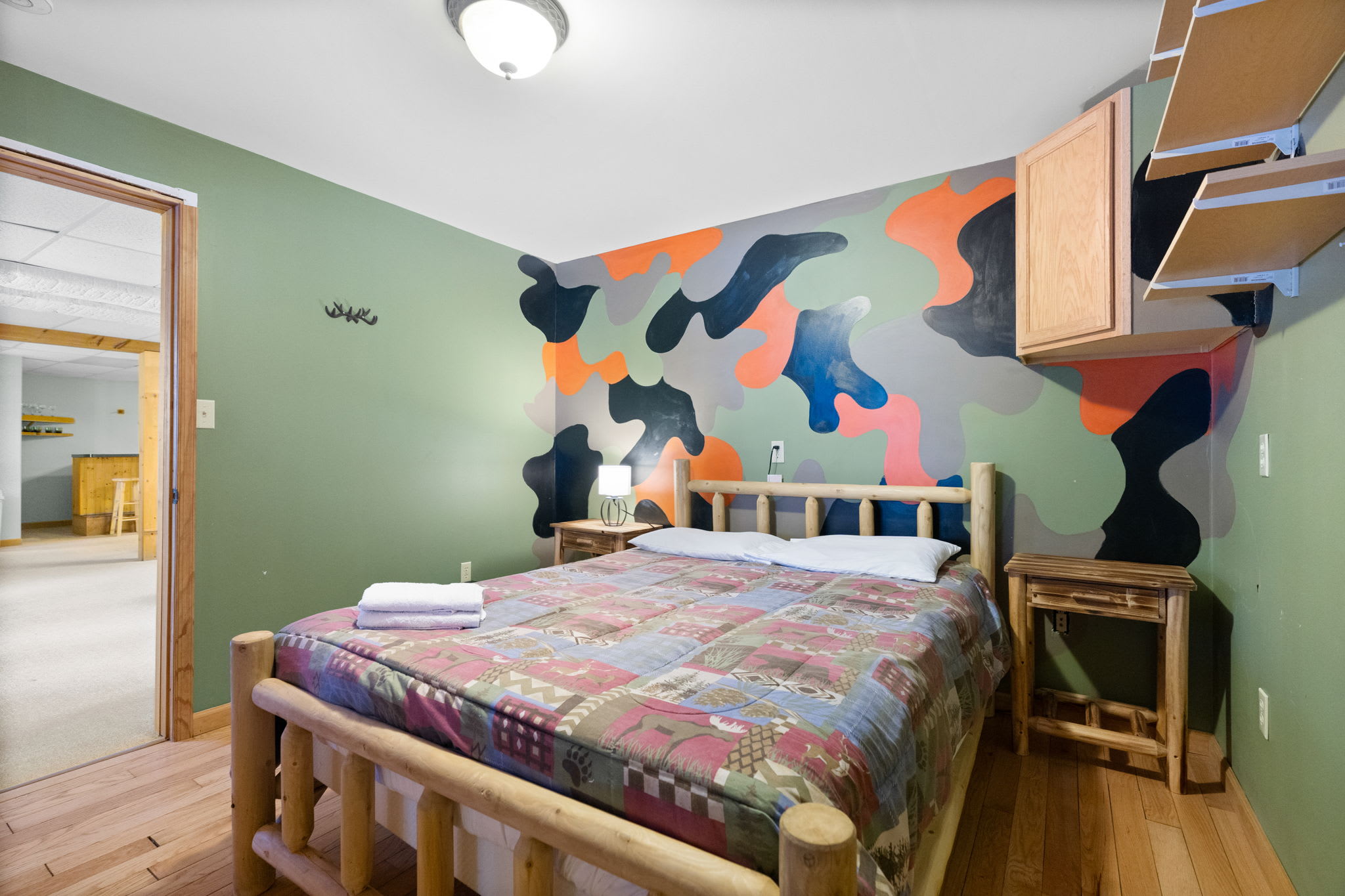 Colorful bunk room with teal walls and plenty of sleeping space for the kids