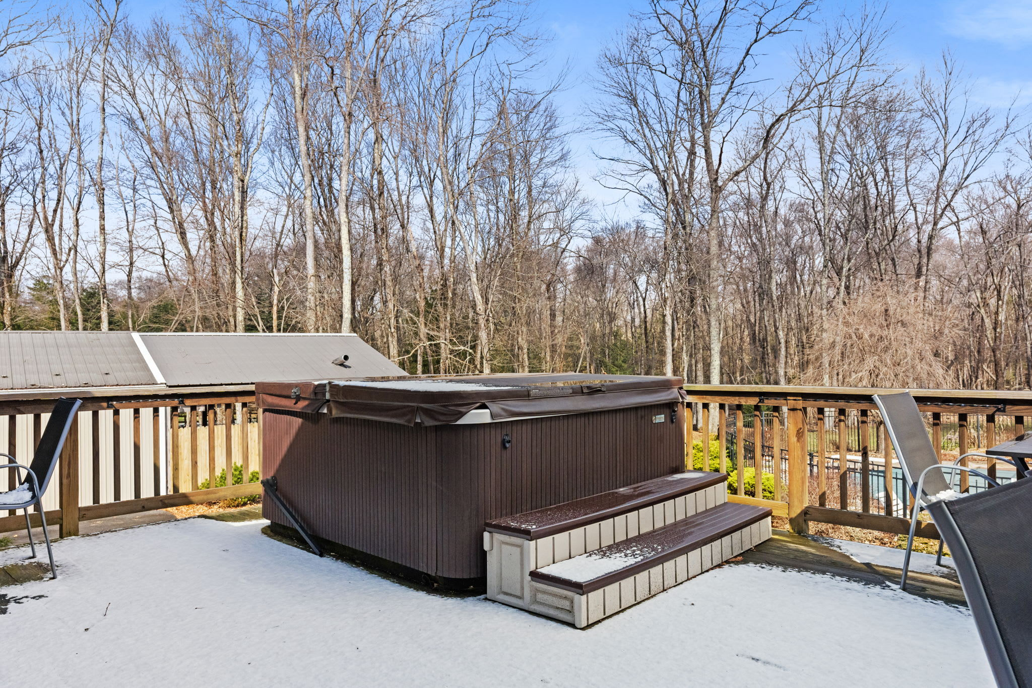 Soak under the stars in the hot tub surrounded by peaceful wooded views