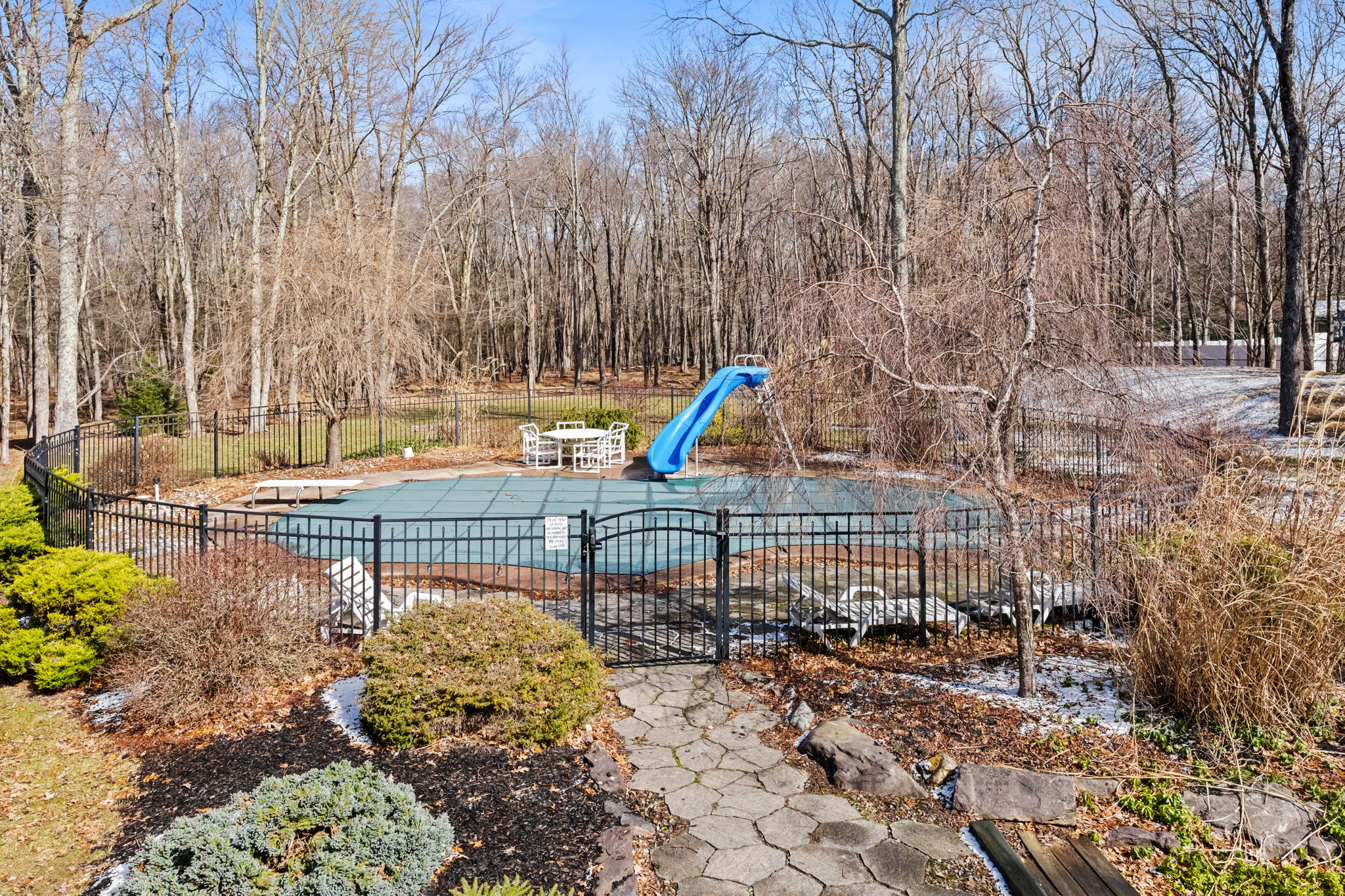 Cool off in the fenced pool area with a water slide for the kids