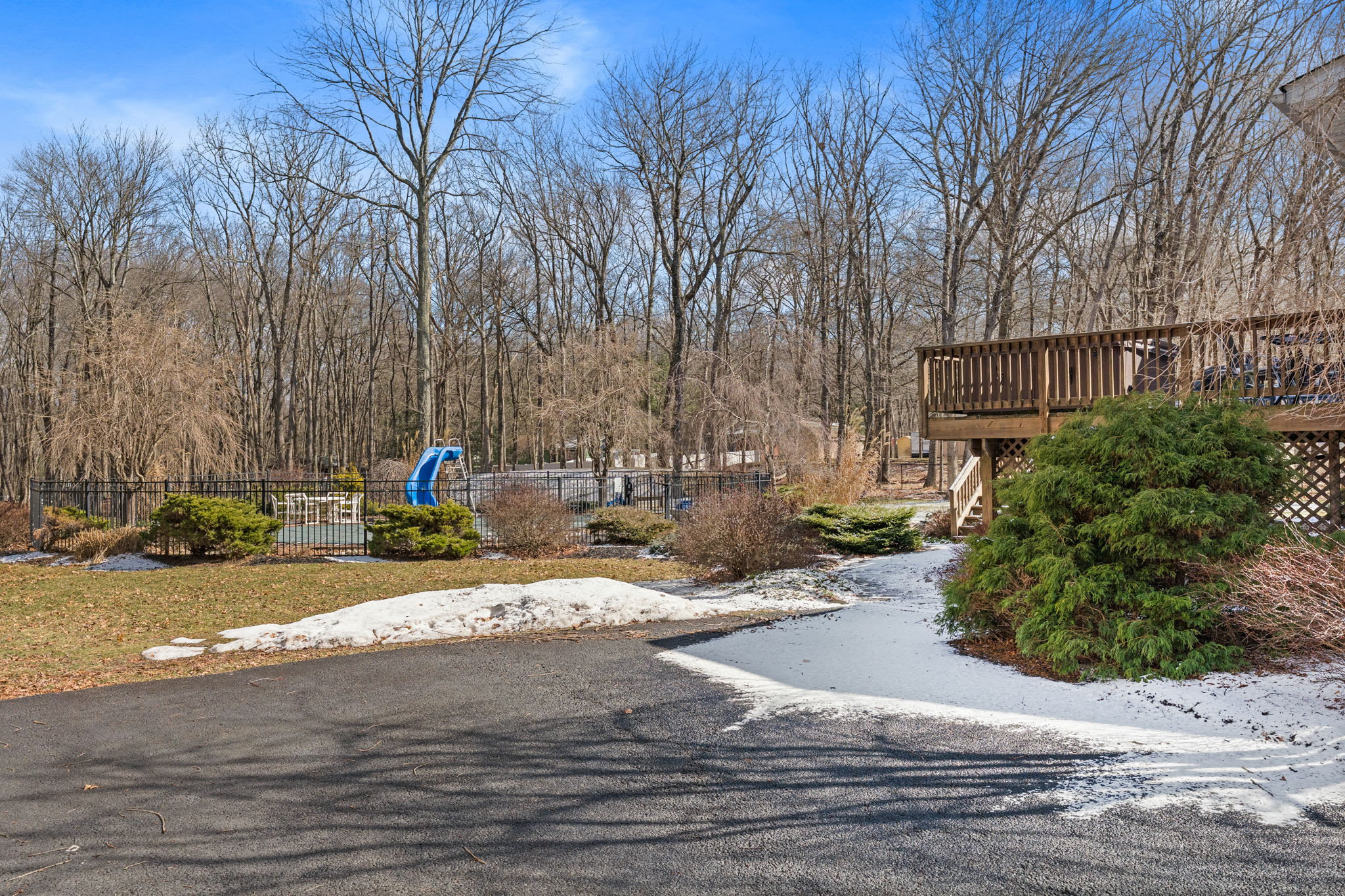 Arrive to the spacious property with a wide driveway and cabin tucked in the trees