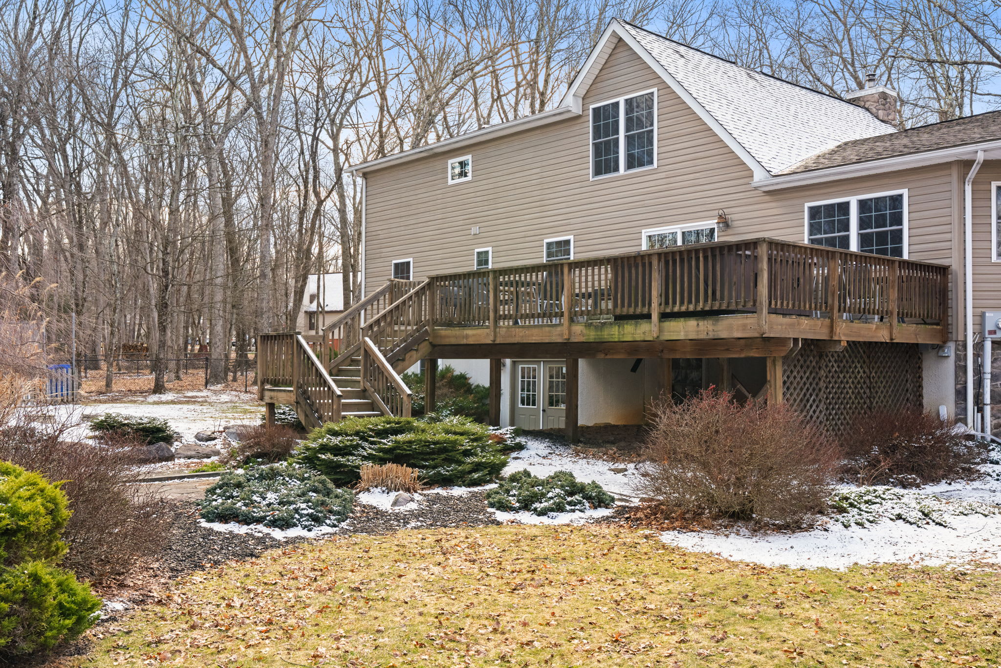 Full view of the A-frame cabin with upper and lower decks overlooking the property