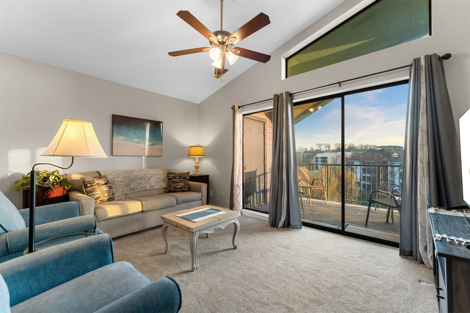 Open living space with Queen sofa sleeper, TV, and balcony access