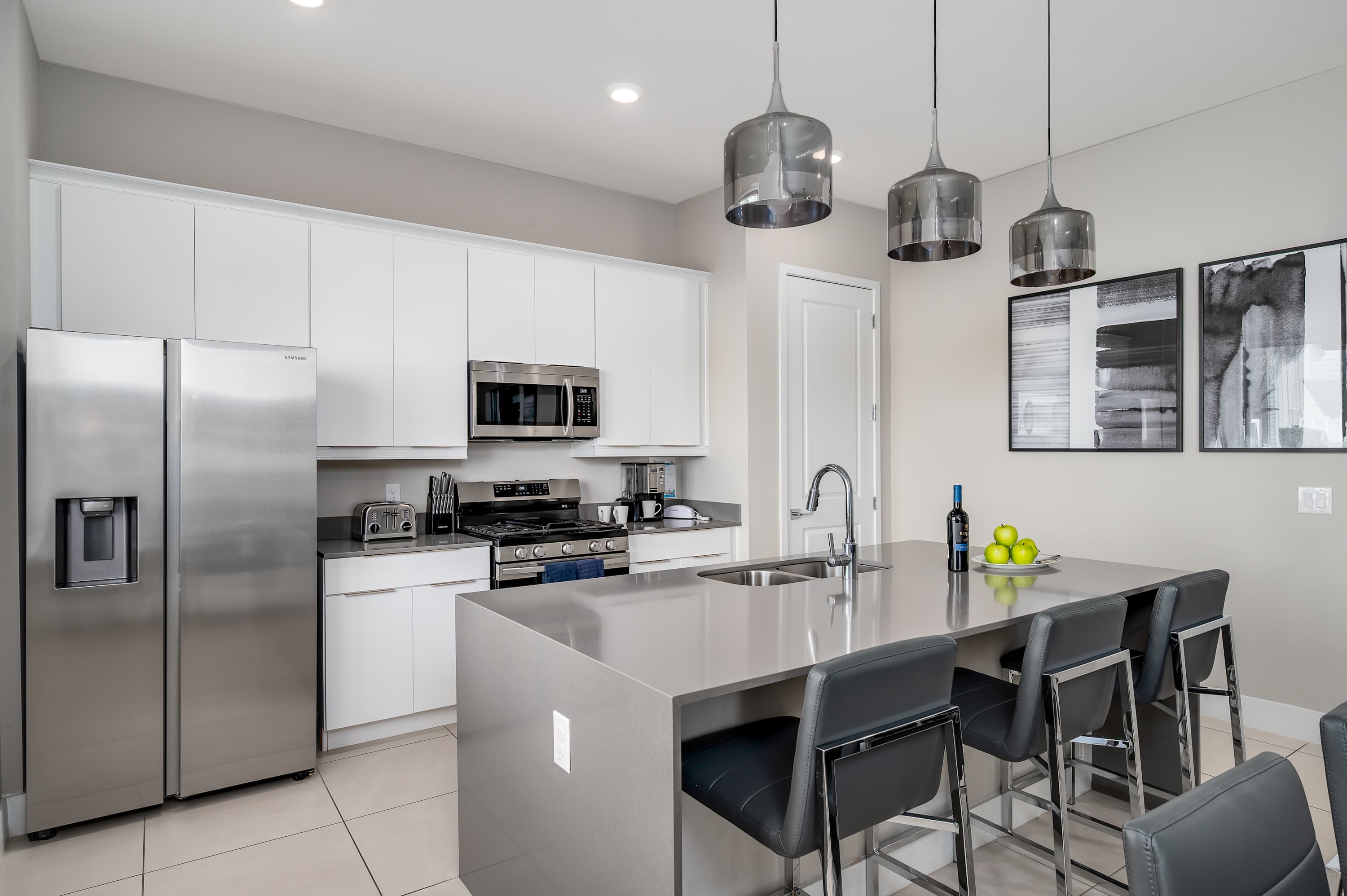 Modern kitchen with stainless steel appliances and a large island for casual dining.