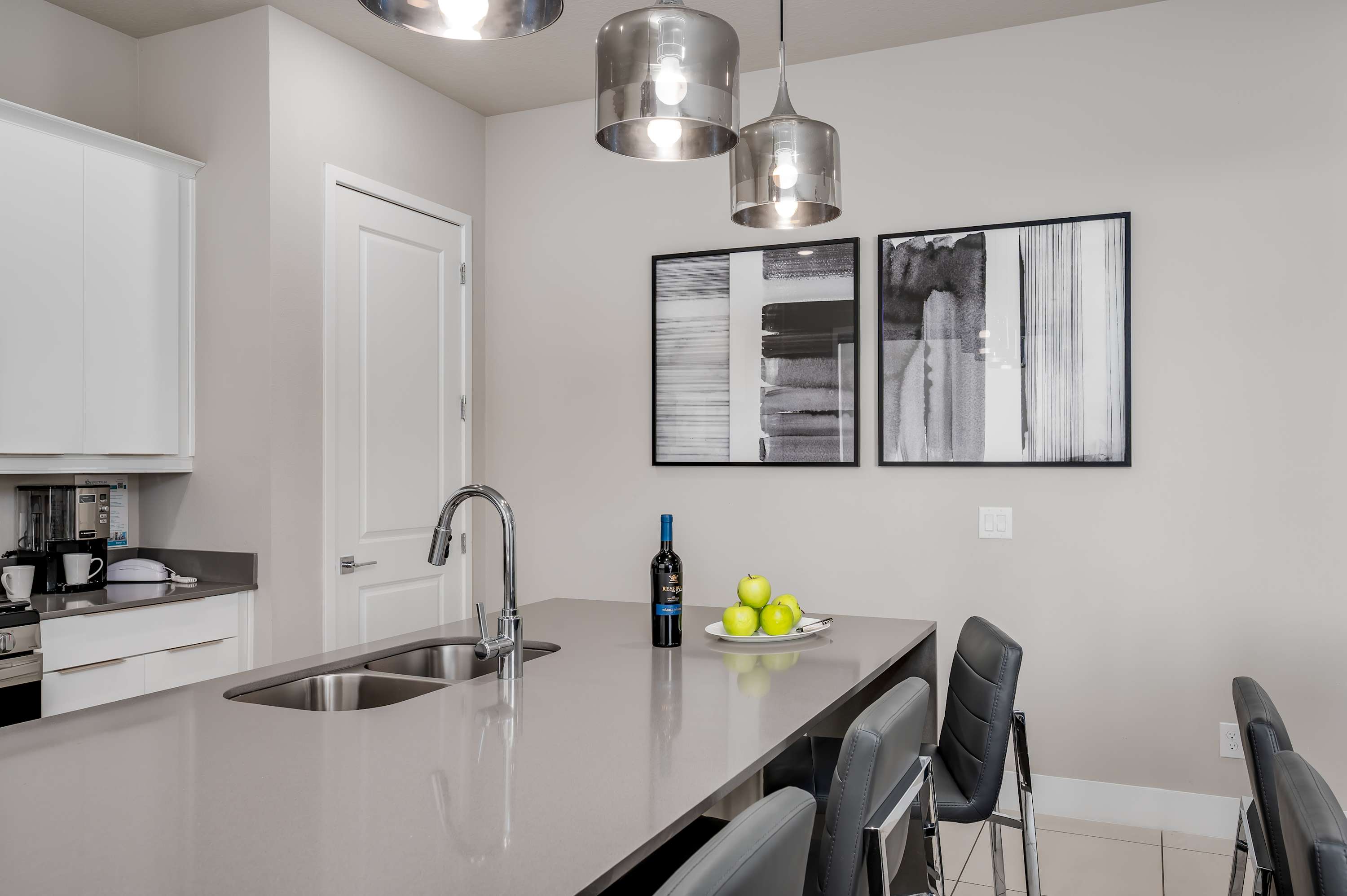 Modern kitchen island with seating and contemporary pendant lighting
