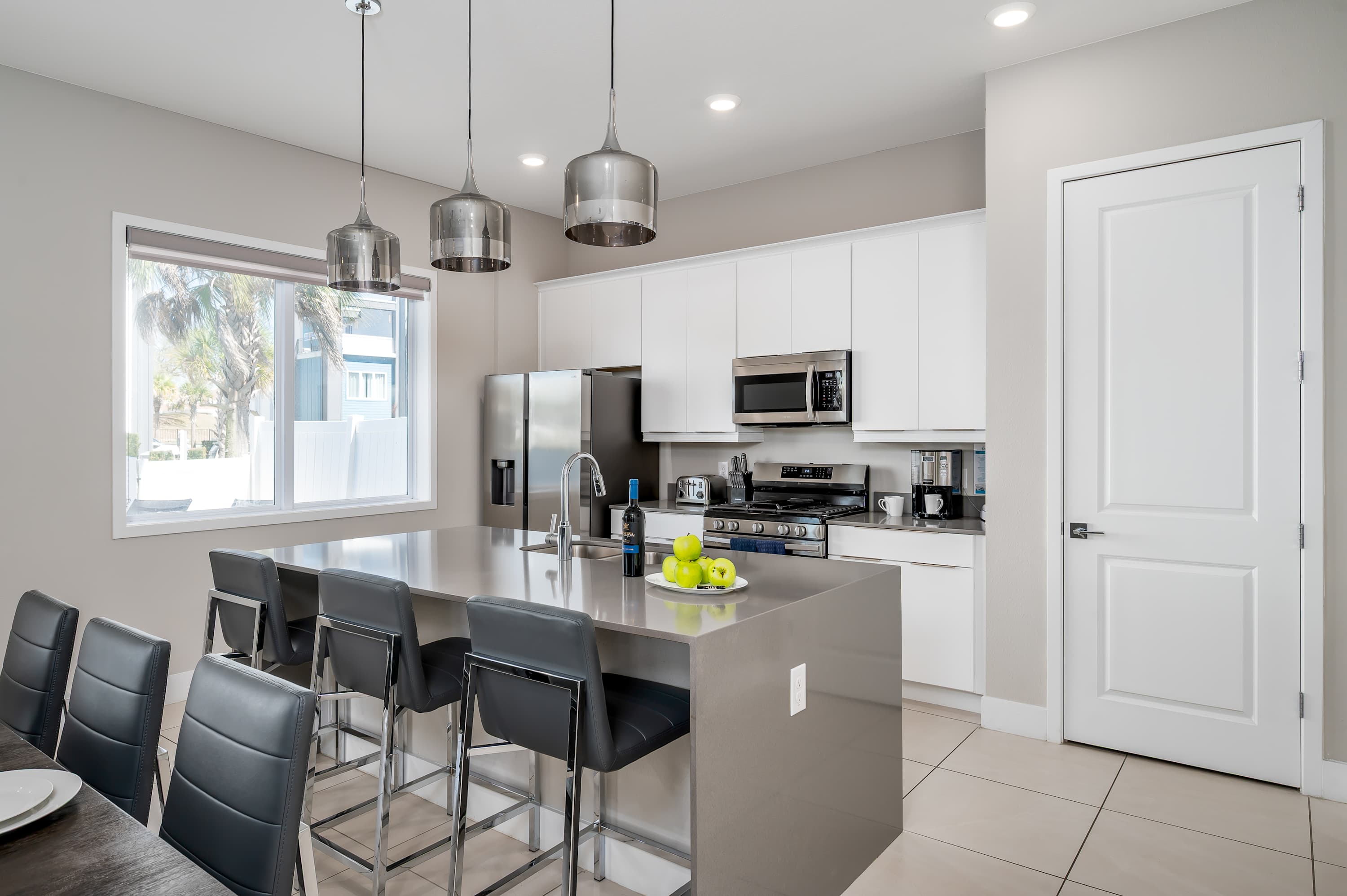 Modern kitchen with stainless steel appliances and a large island for casual dining.