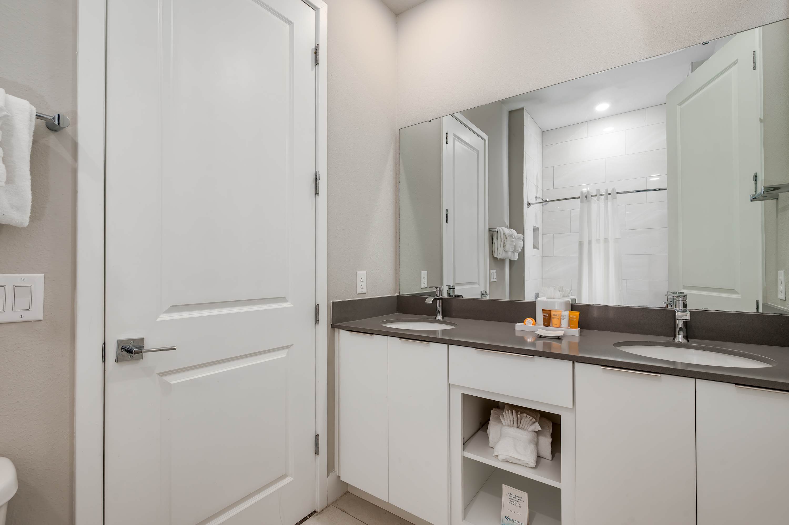 Modern bathroom with dual sinks and a large mirror for convenience.