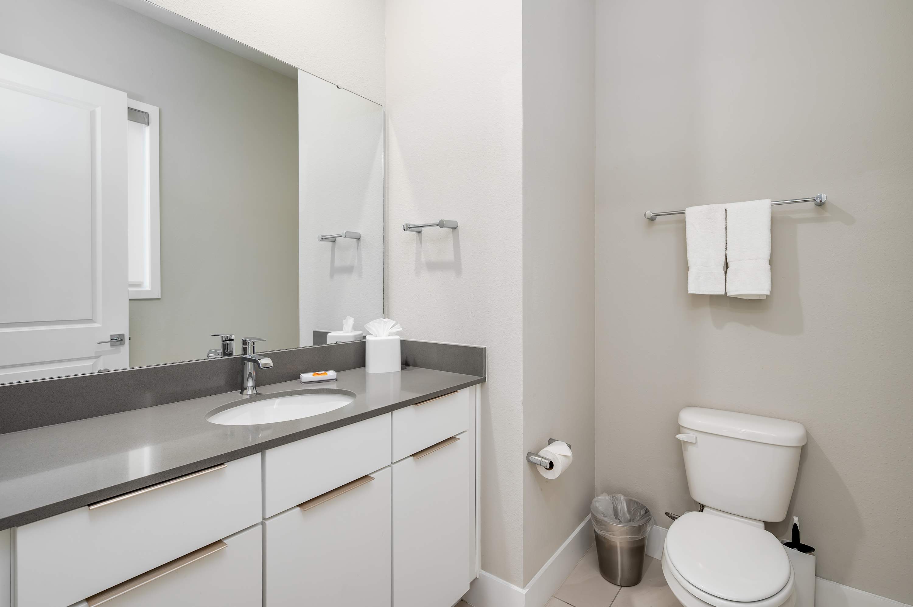 Modern bathroom with a sleek countertop and clean white cabinetry