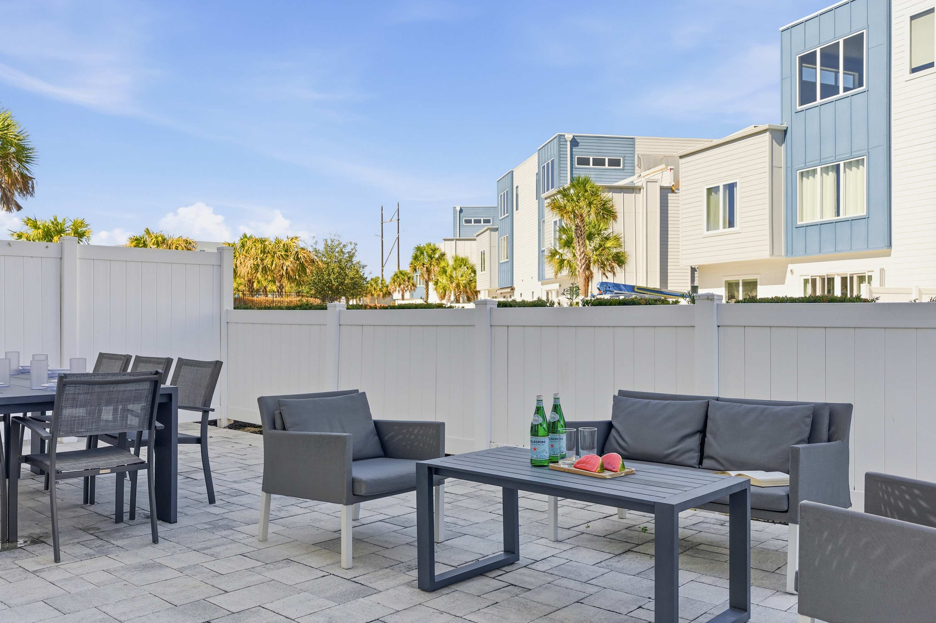 Outdoor patio with modern seating and dining area for relaxing or entertaining.