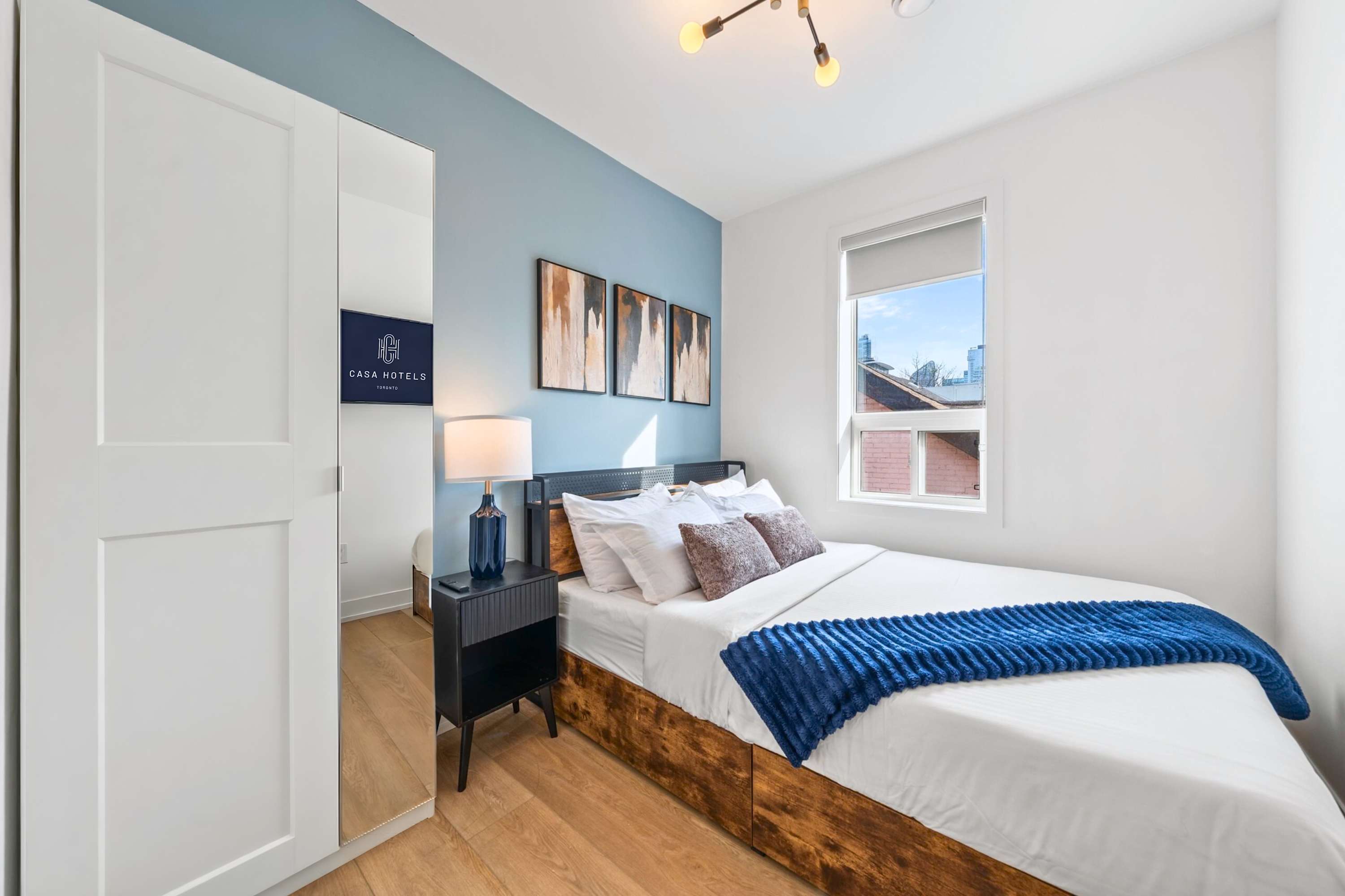 Cozy bedroom with a comfortable bed, natural light, and modern decor.