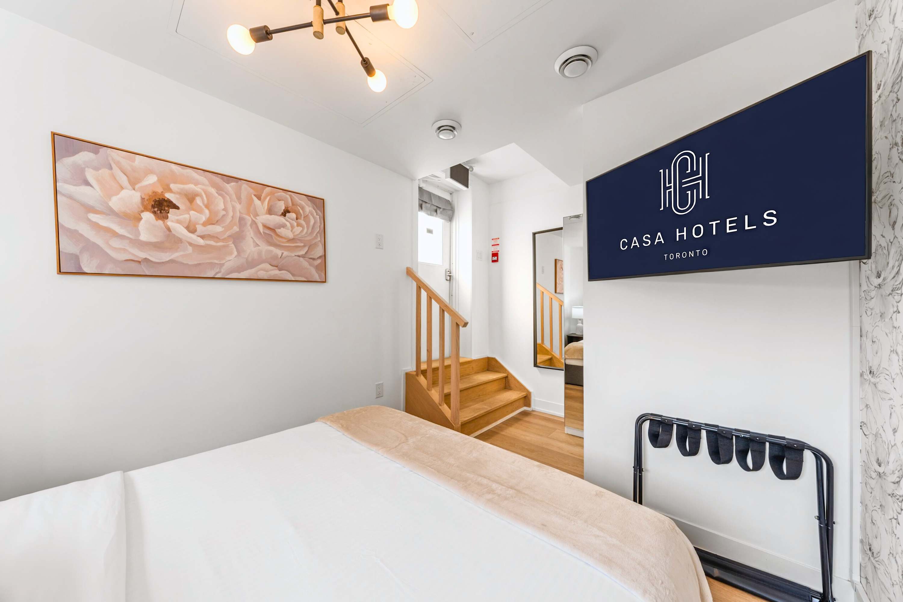 Bedroom with staircase access and Smart TV.
