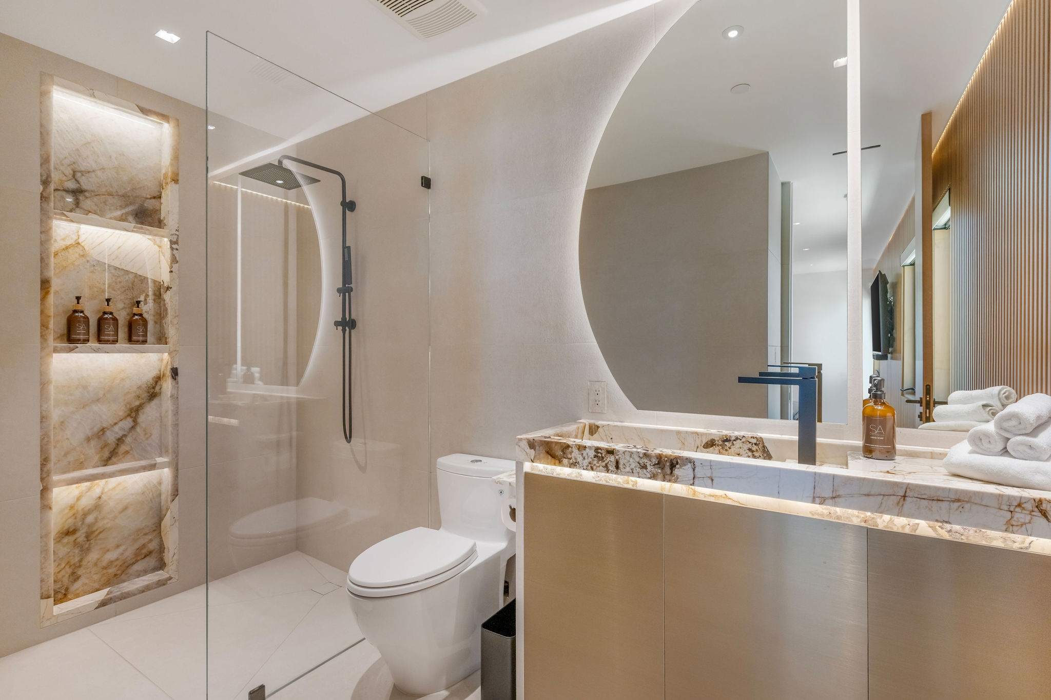 Spa bathroom with floating vanity, walk-in shower, and custom lighting.