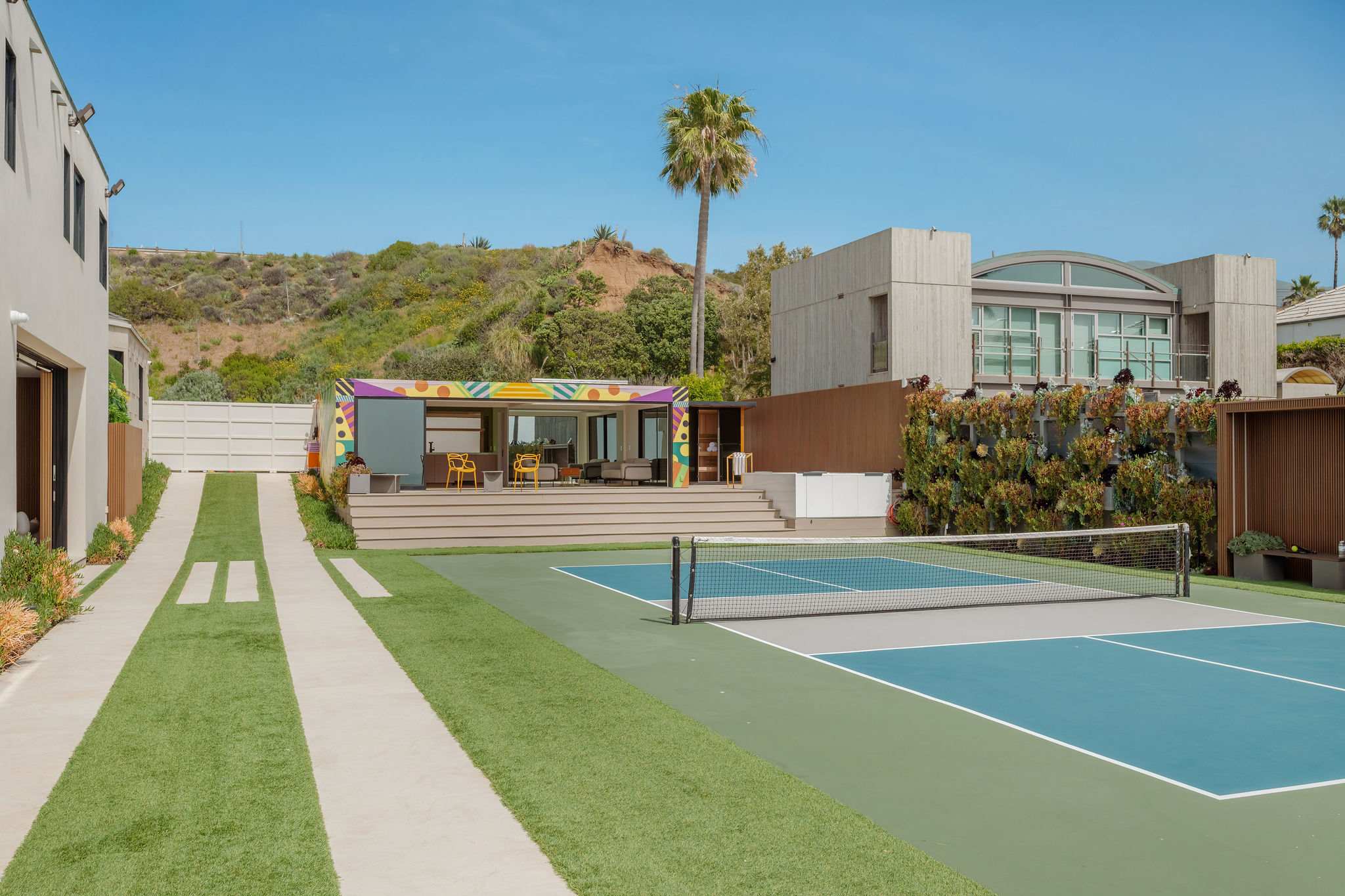 Private sport court alongside guest house and landscaped Malibu grounds.