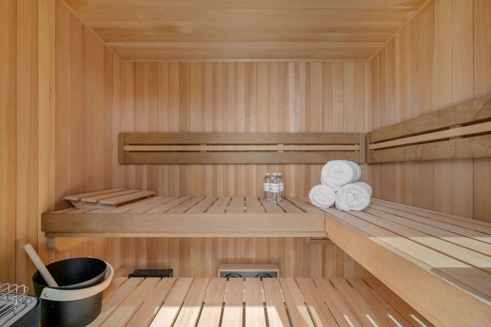 Custom-built sauna with full wood interior and tiered bench seating.