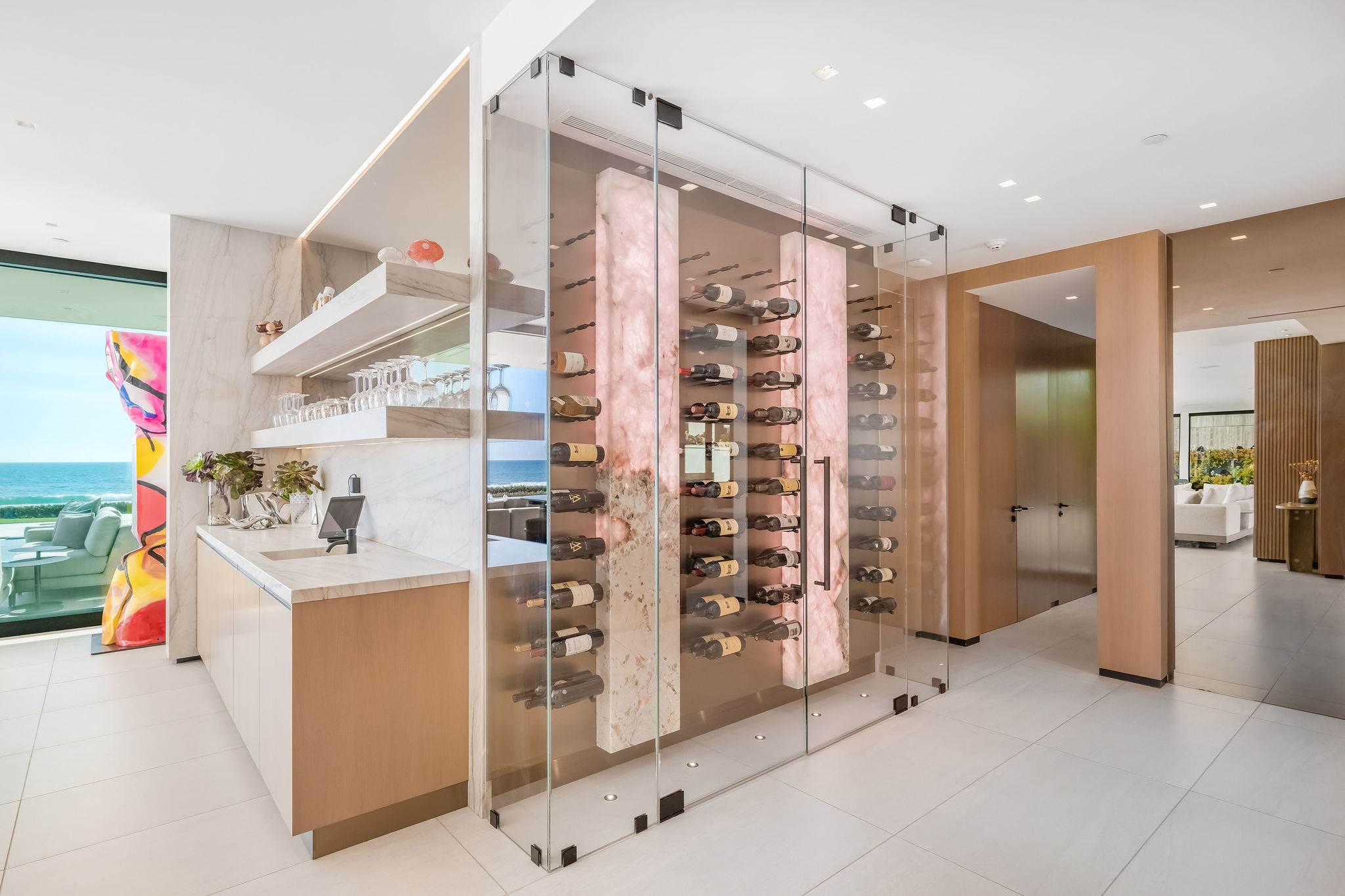 Glass wine display and bar area designed for entertaining and storage.