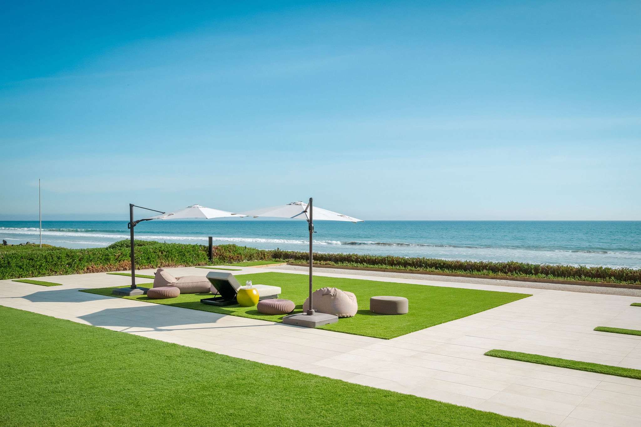 From the lawn, step directly onto the sand from your beachfront setting.