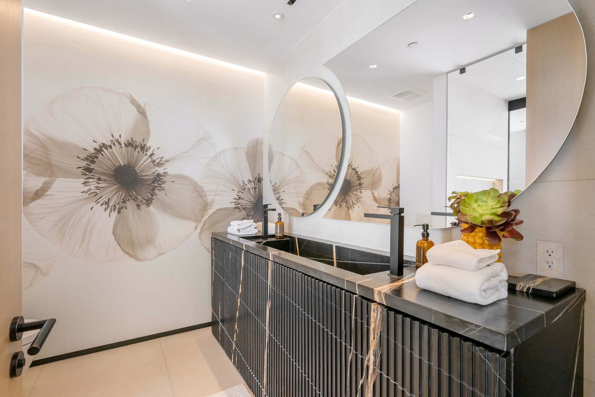 Designer powder room with statement vanity and custom wall finishes.