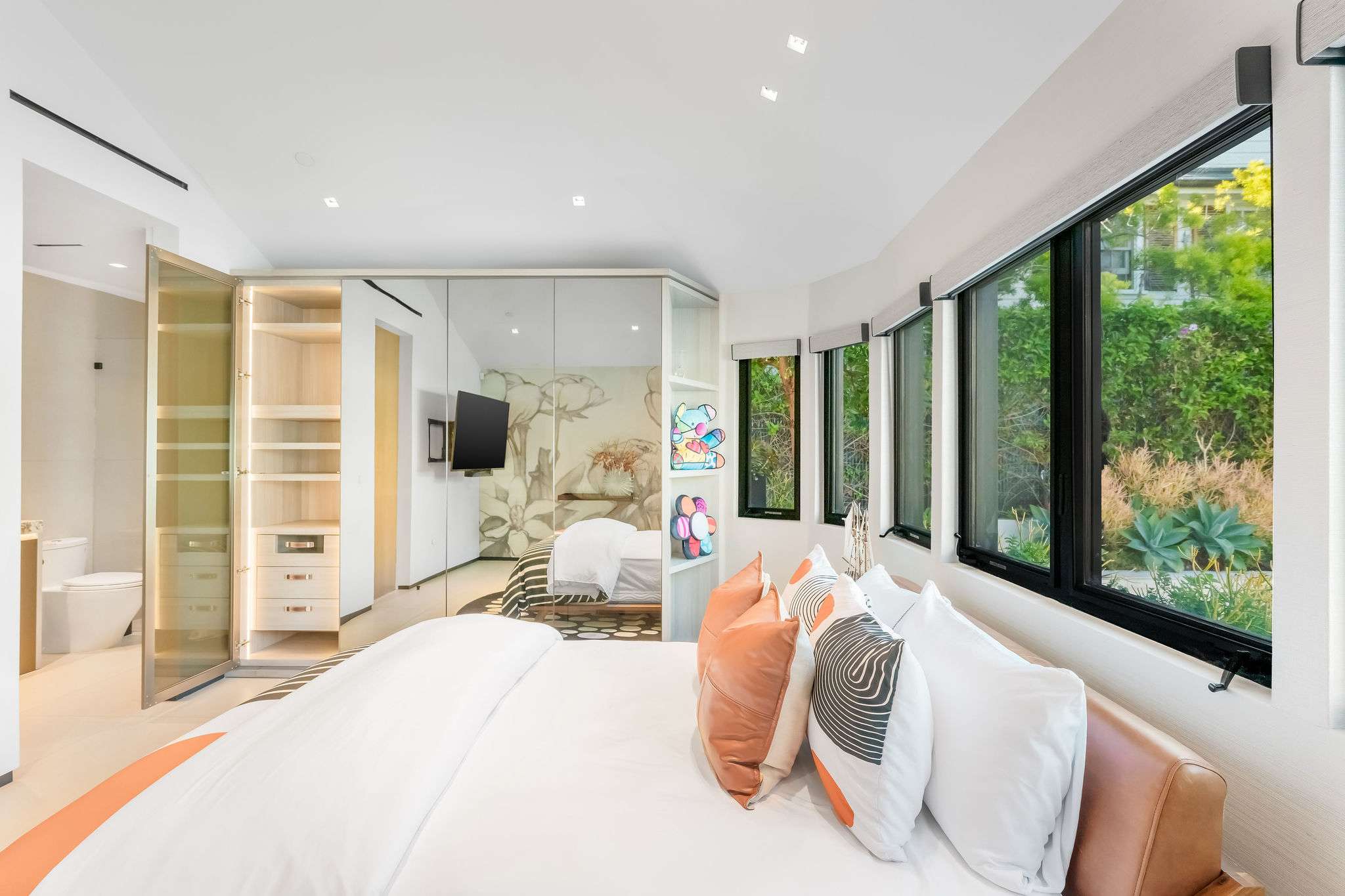 Bedroom suite with extended layout and full-length window line.
