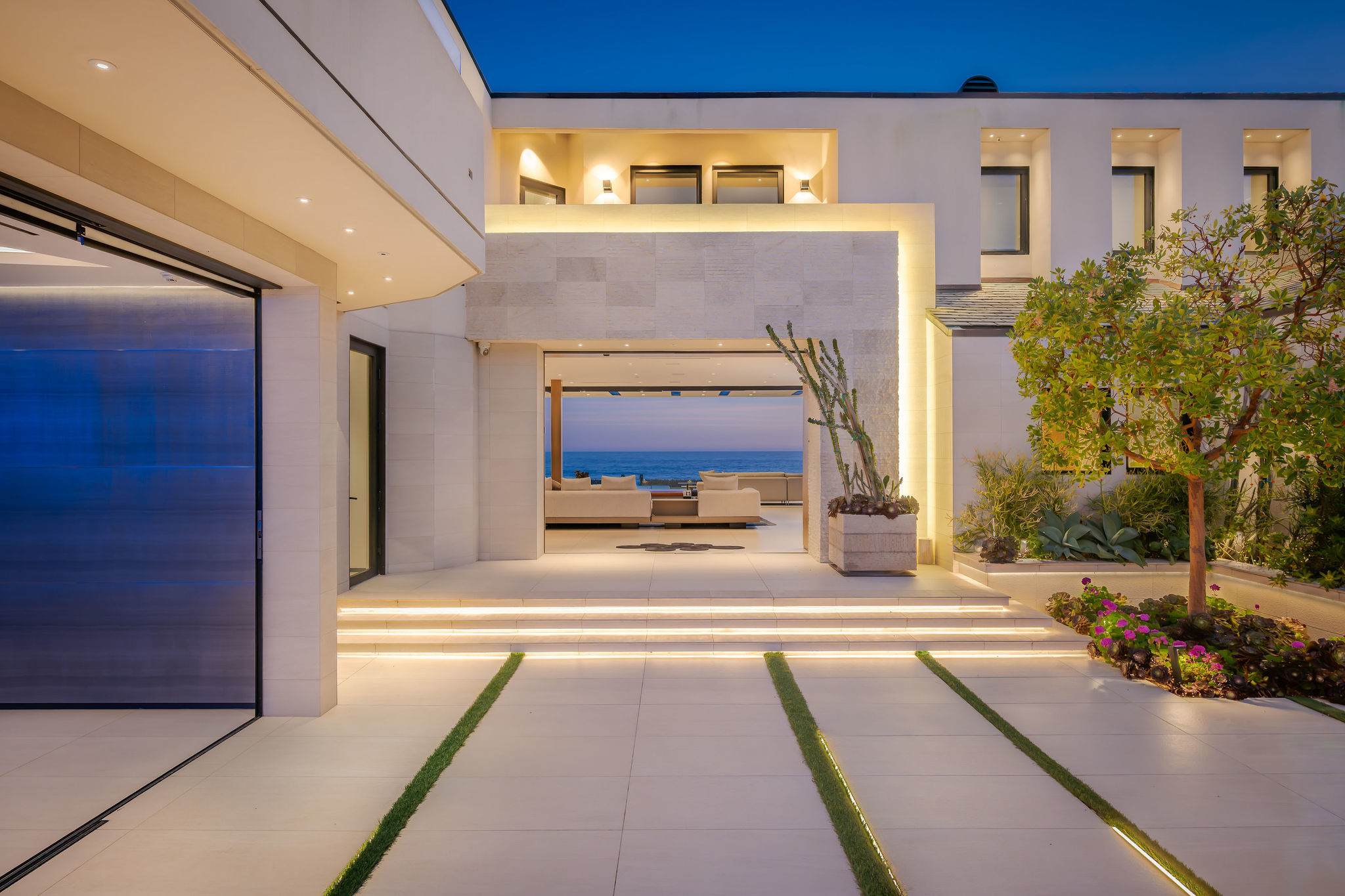 Arrive through a framed entry that opens straight toward the ocean view.
