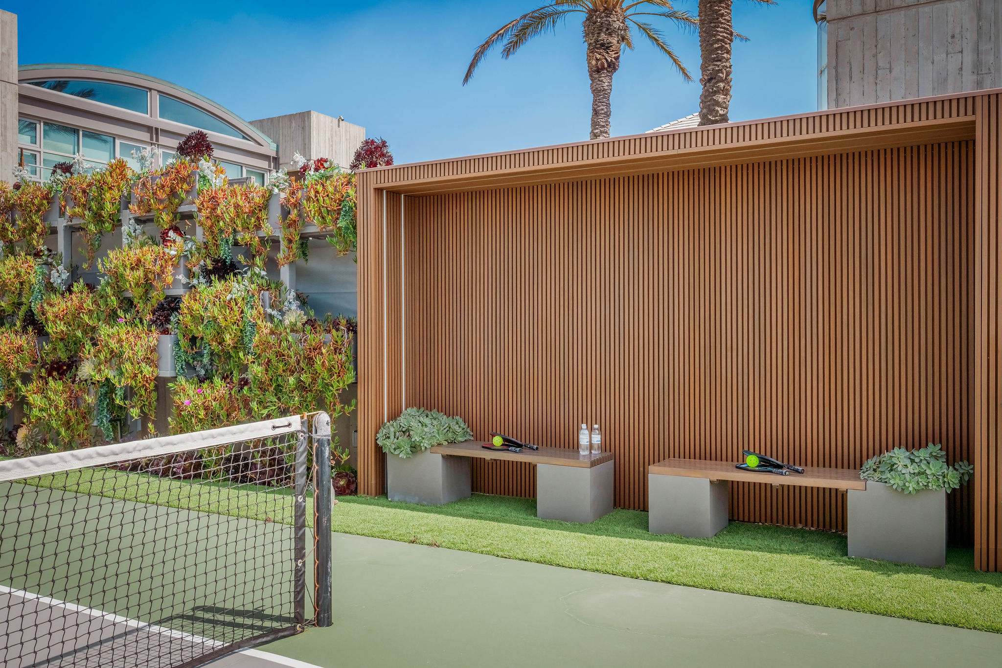 Dedicated lounge seating positioned alongside the private sport court.