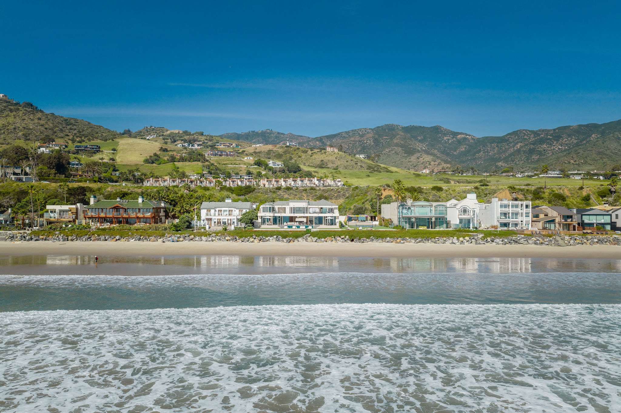 Direct Broad Beach frontage with wide sandy shoreline and open ocean views.