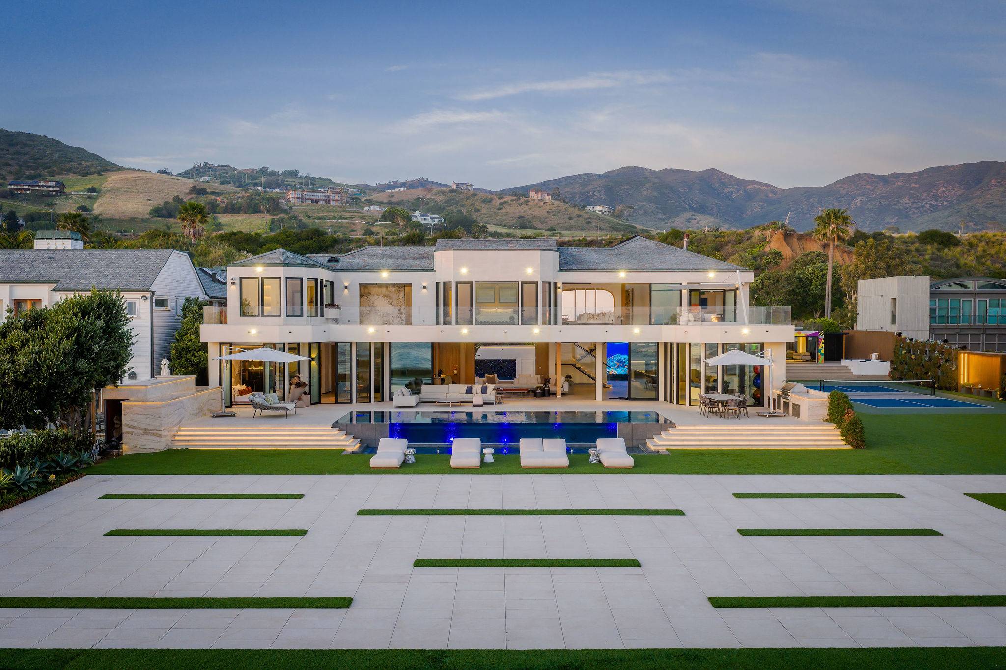 Pool, lawn, and home align across a single beachfront stretch.